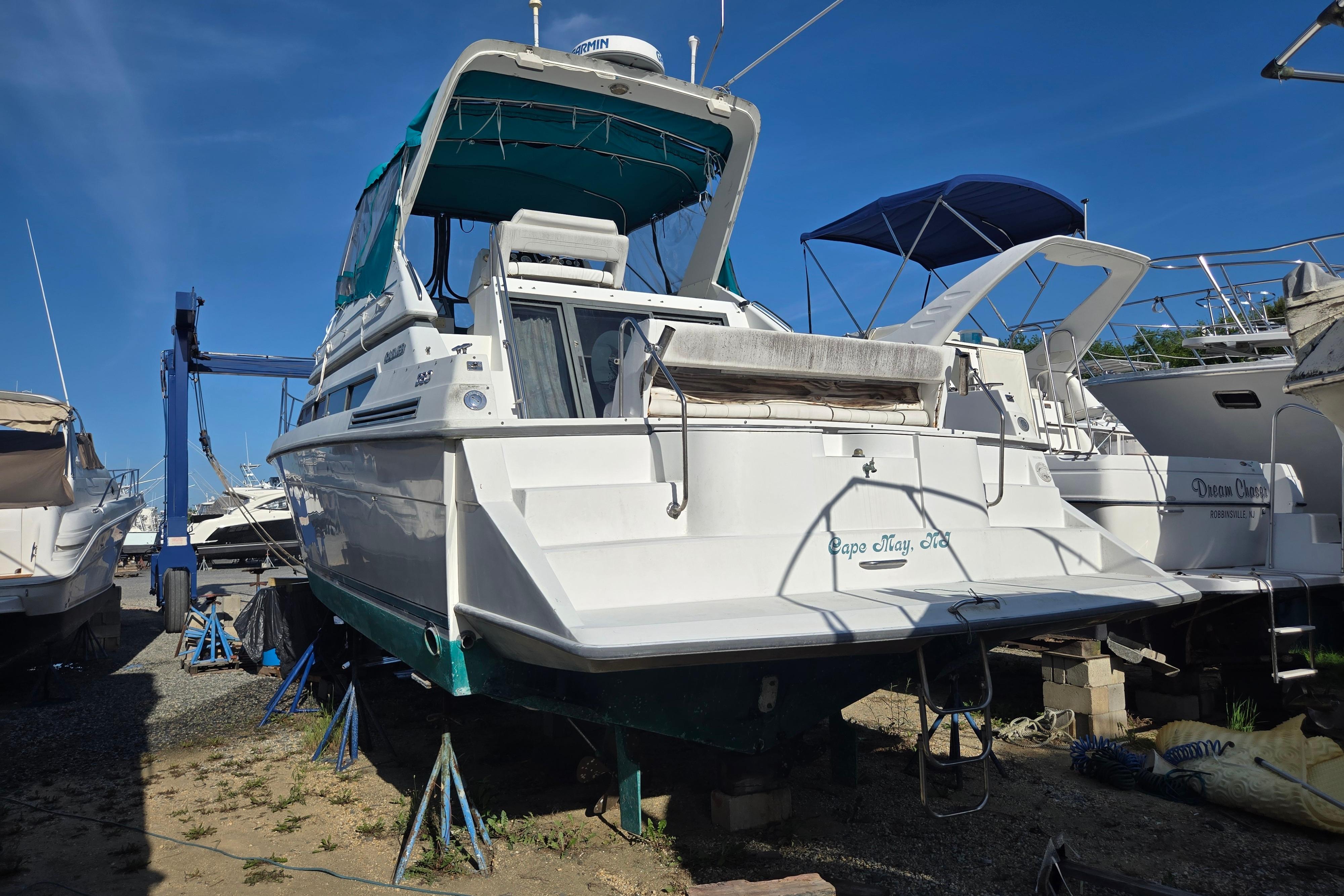 1994 Carver 380 Santego yacht on dry dock, Cape May, NJ, under clear blue sky.