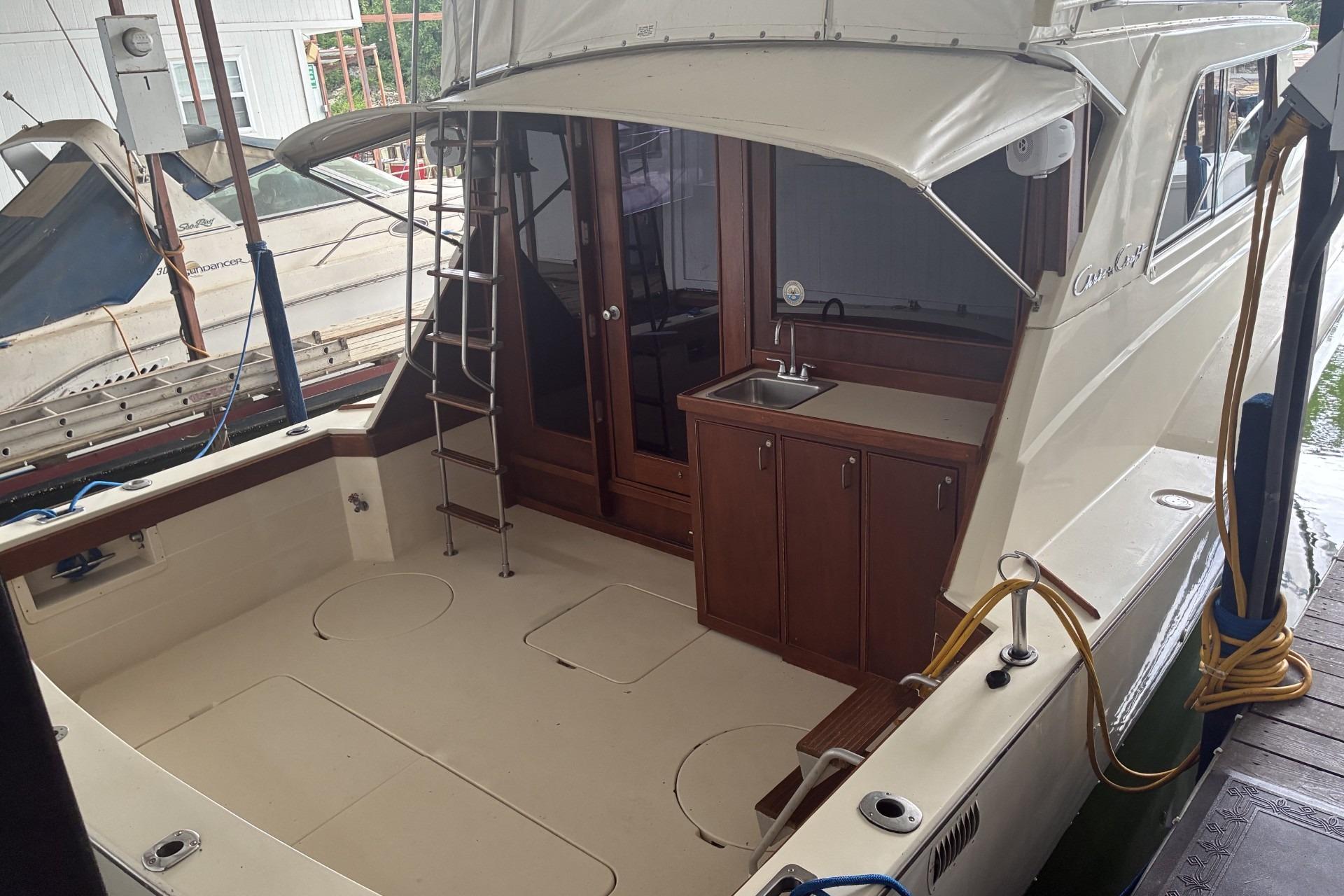 1980 Chris-Craft 360 Commander boat with spacious deck and outdoor sink area.