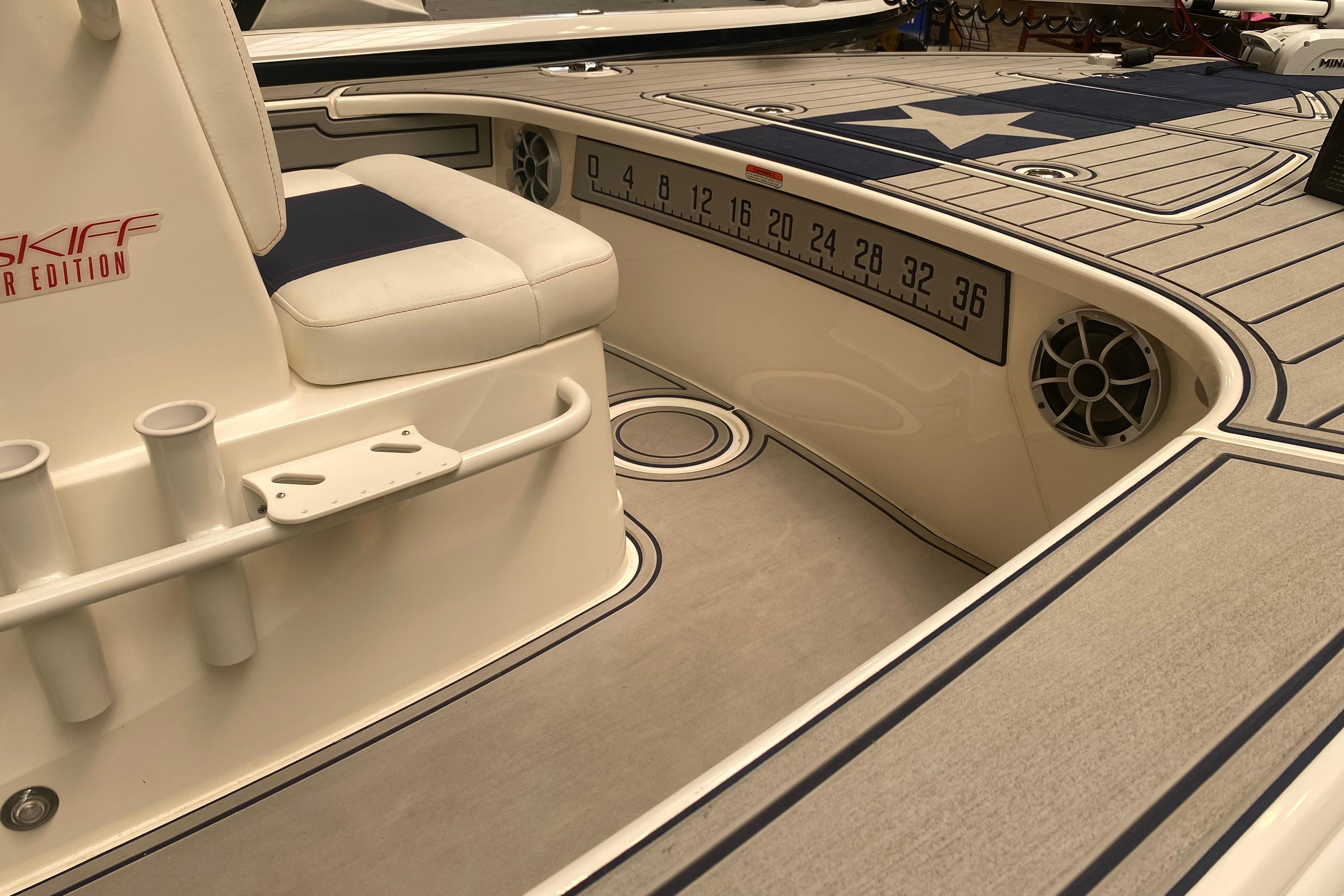 2025 Mako 18 Pro Skiff Patriot Edition interior with seating and measurement markings.