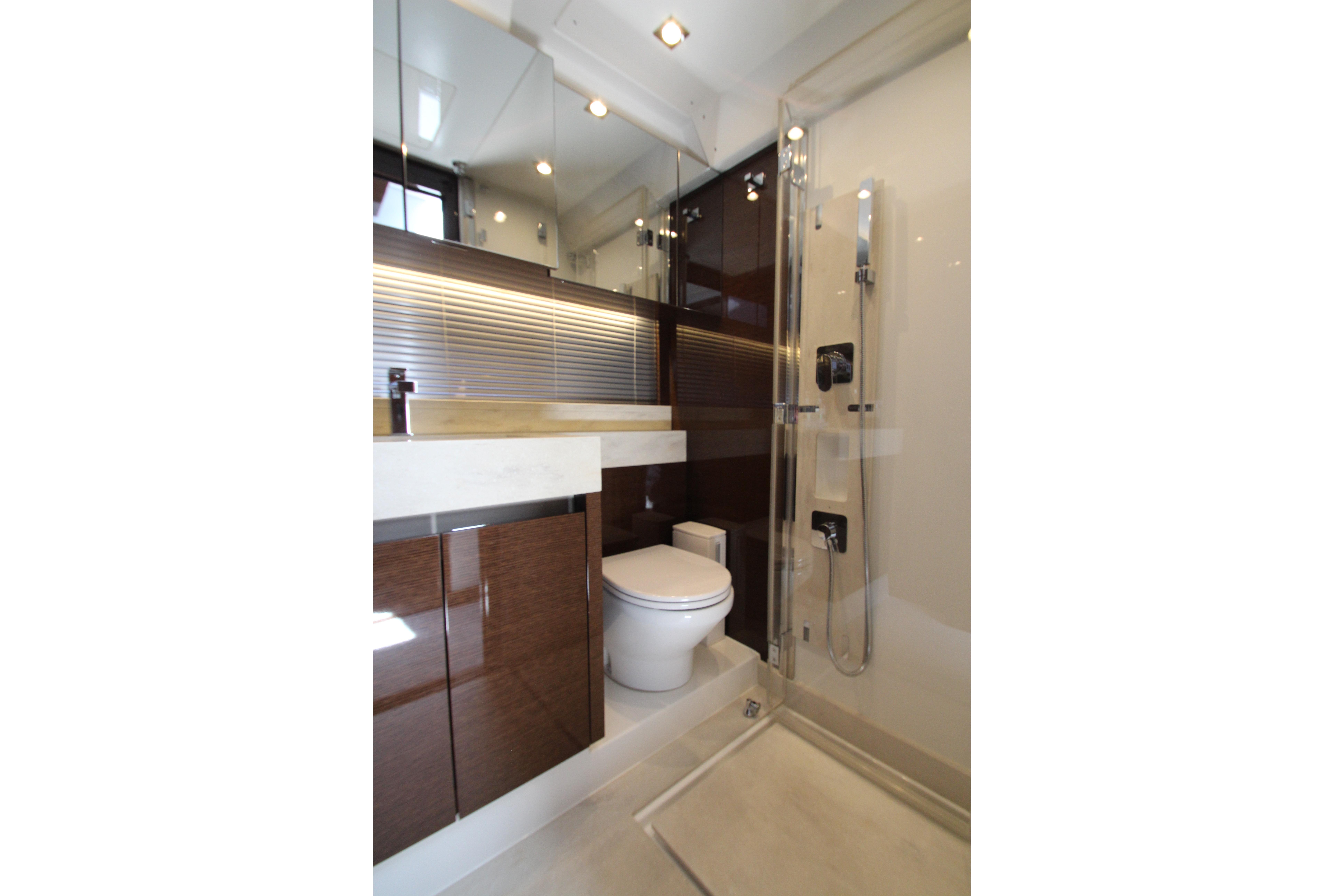 Luxurious bathroom interior of 2022 Prestige 520 yacht, featuring modern fixtures and elegant design.
