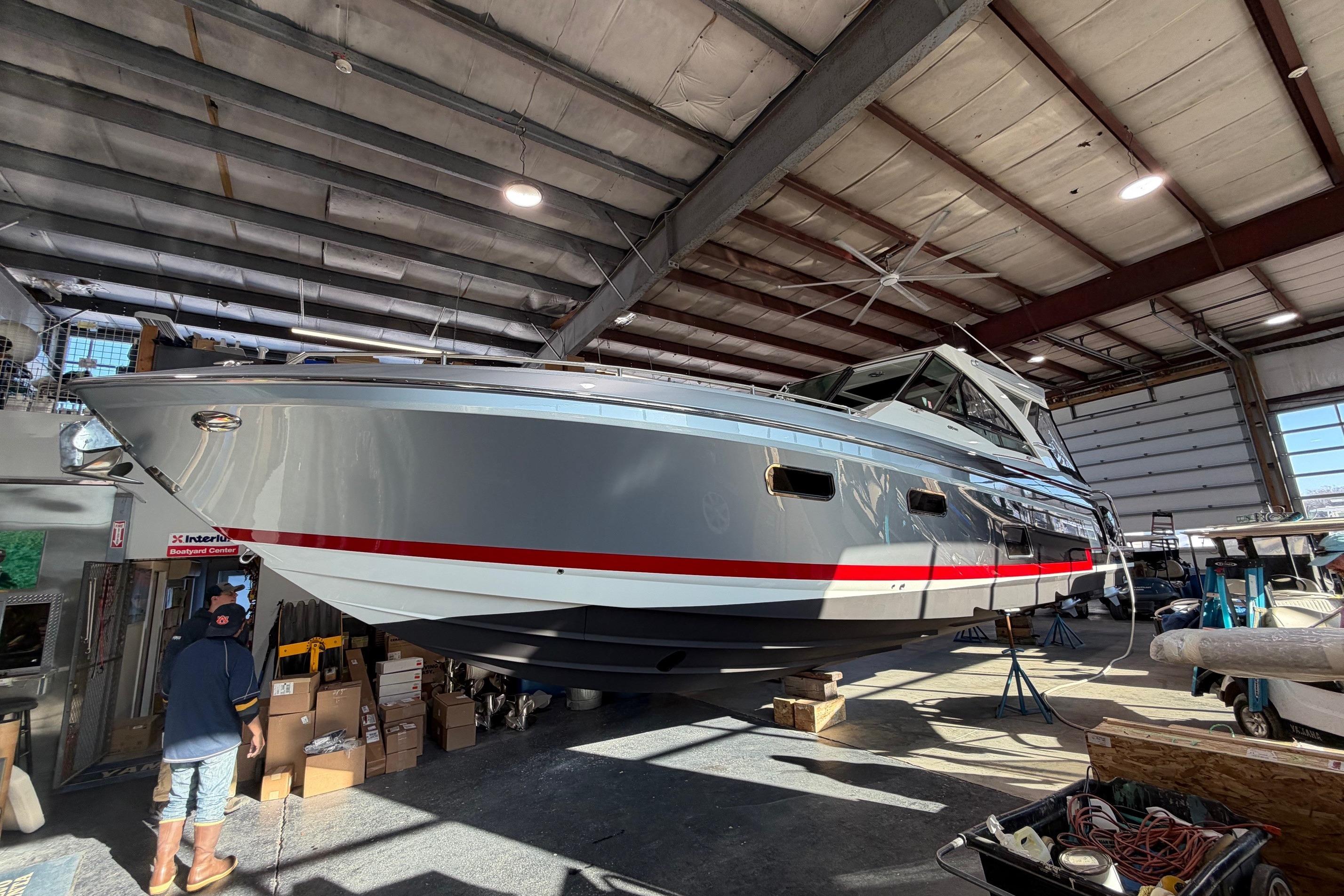 2017 Formula 430 Super Sport Crossover boat in a warehouse, elevated for maintenance.