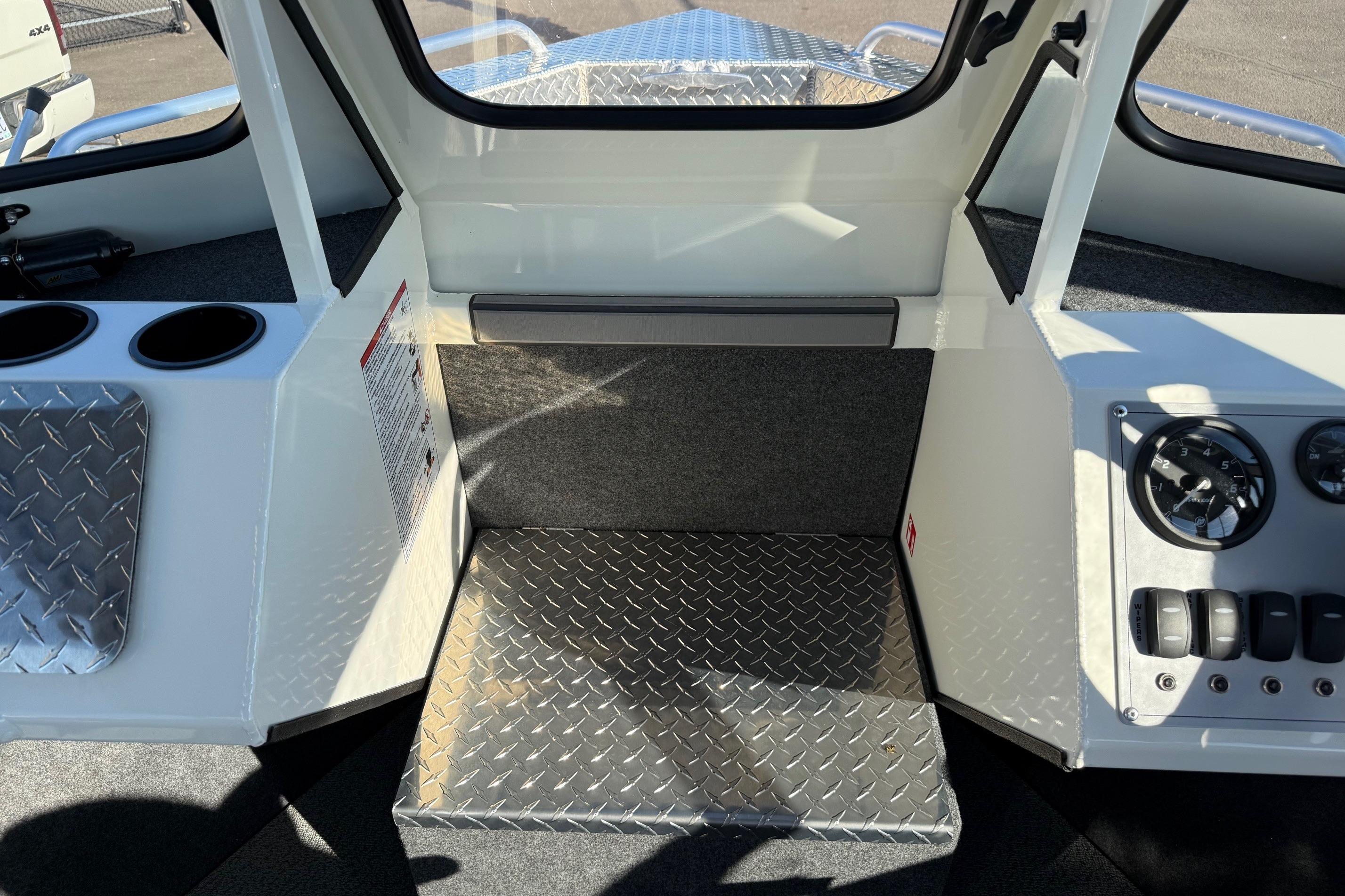 Interior of 2026 Thunder Jet 185 Luxor boat with diamond plate flooring and control panel.