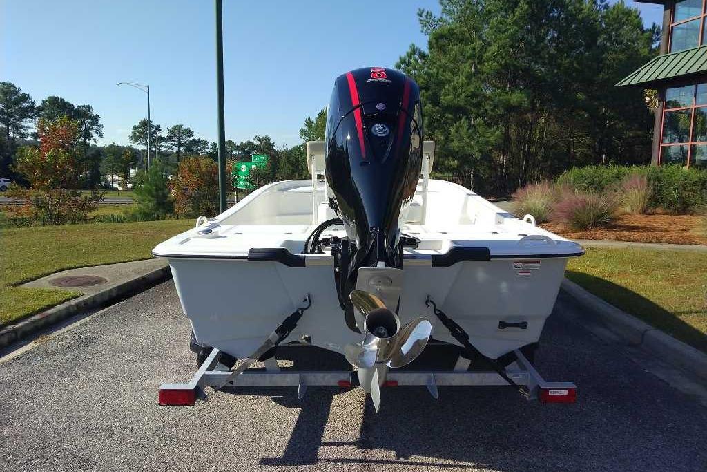 2026 Mako Pro Skiff 19 CC boat on trailer, rear view, outdoors.