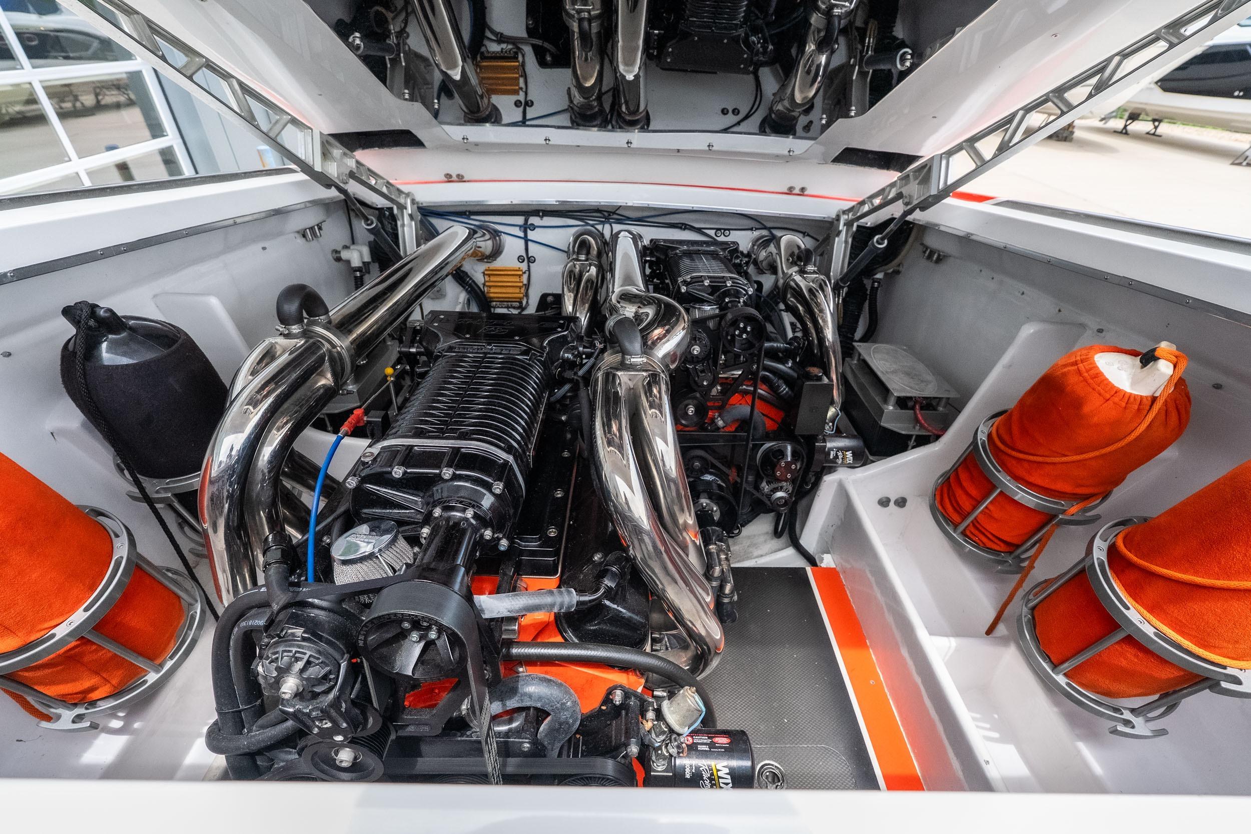 Engine compartment of a 2006 Cigarette 39' Top Gun Unlimited boat, showcasing powerful machinery.