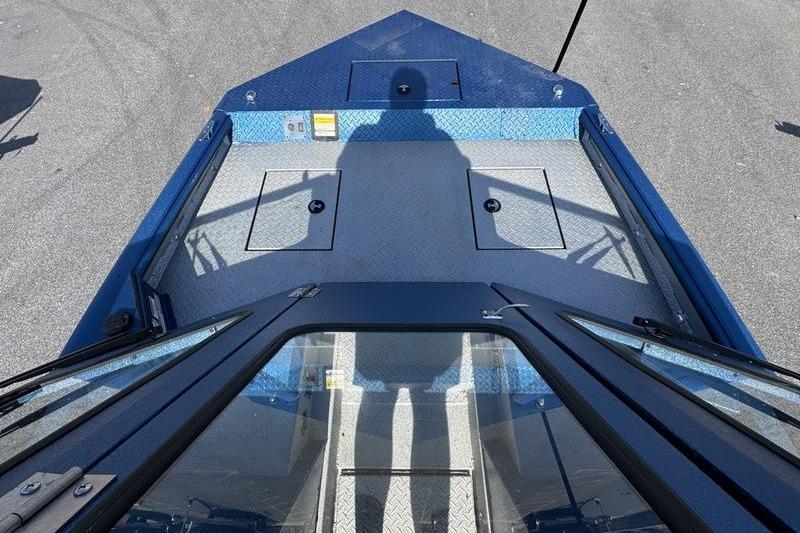 2026 SeaArk Dynasty 2.0 boat deck with shadow, featuring blue and gray design.