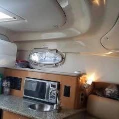 Interior of the 2006 Robalo R265 Walkaround featuring a kitchenette and microwave.