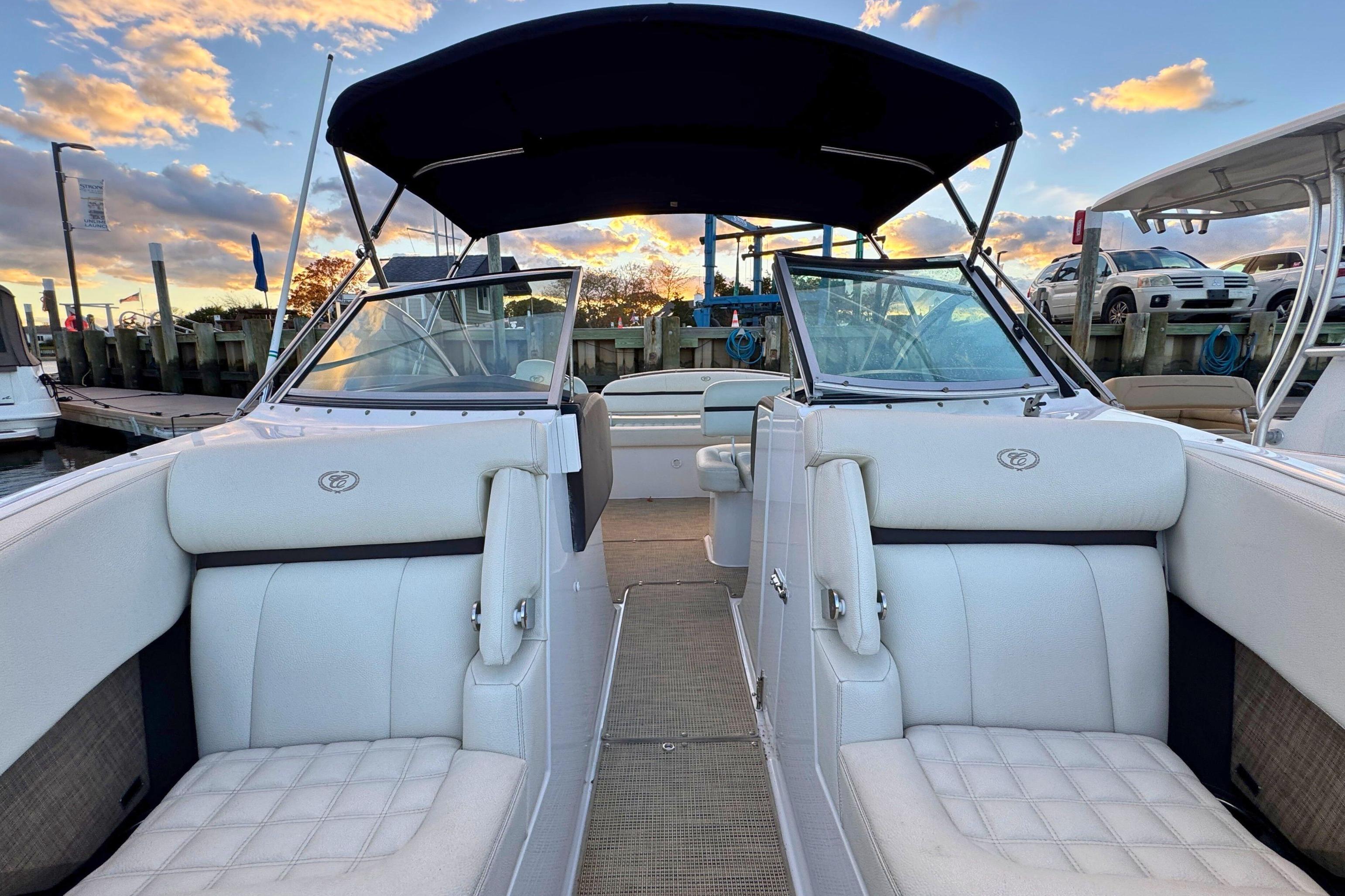 2019 Cobalt R3 boat with white seating, docked at sunset.