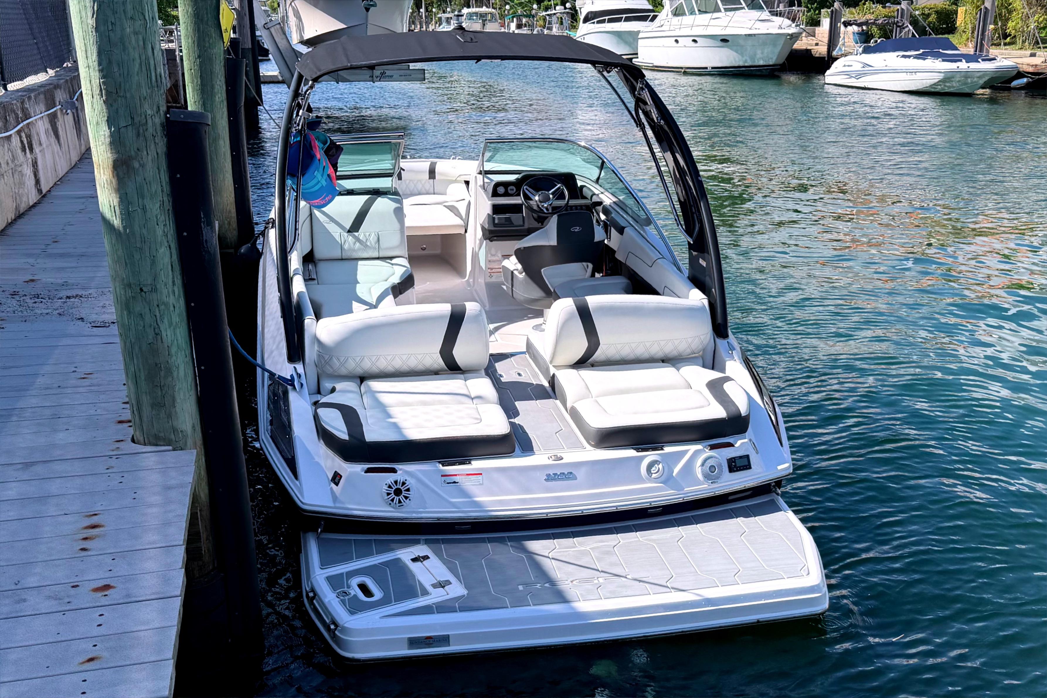 2020 Regal 2300 Bowrider boat docked on calm water, featuring spacious seating and modern design.