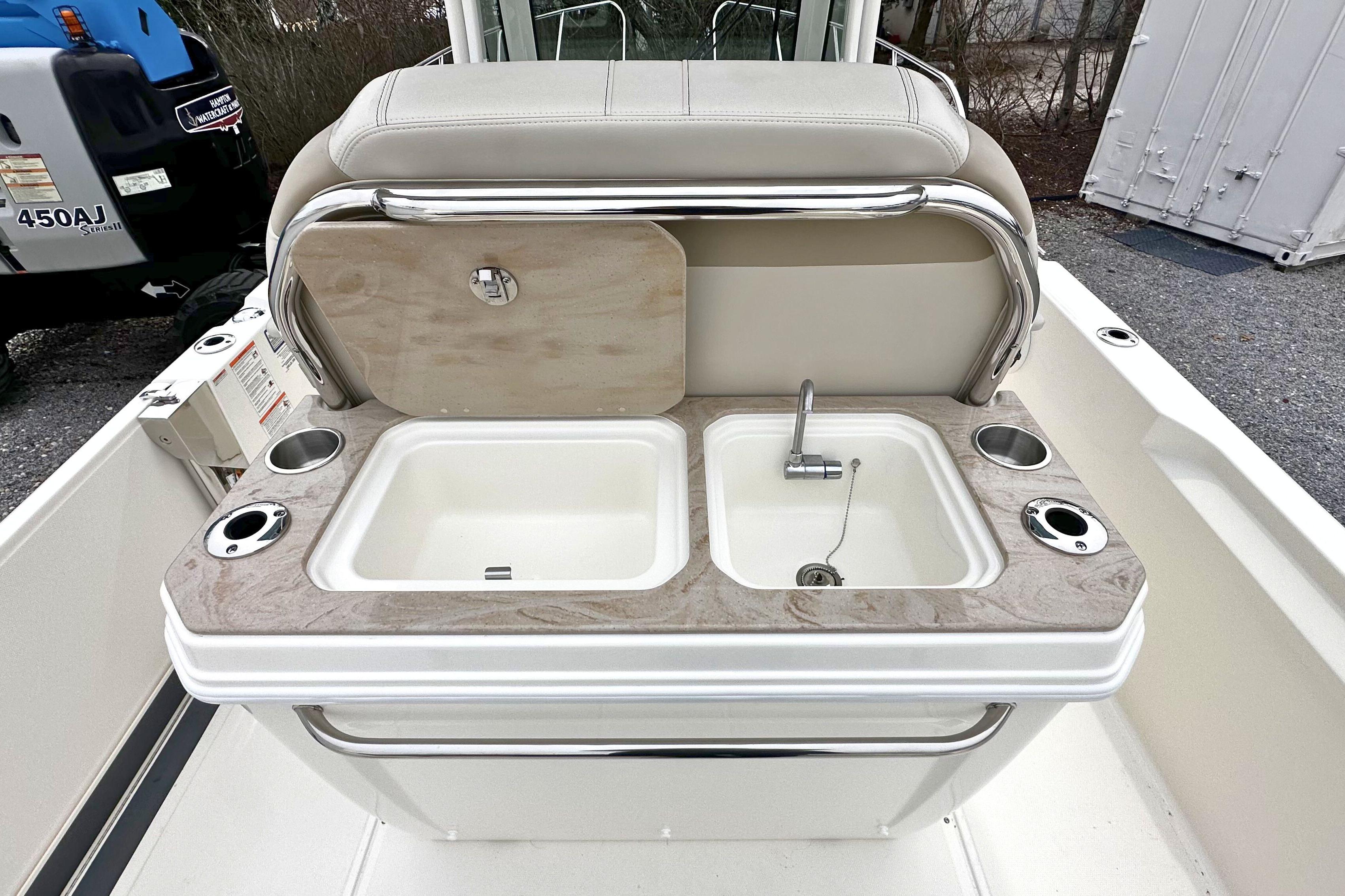 2026 Boston Whaler 280 Dauntless boat sink and countertop with cup holders.