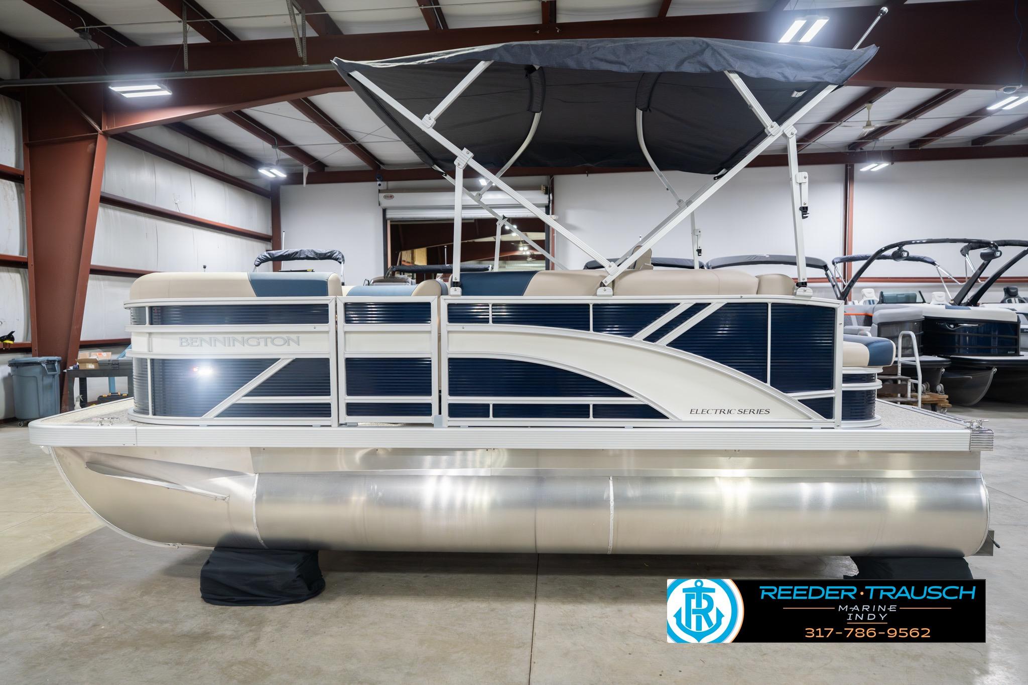 2026 Bennington 168 SLJ pontoon boat in showroom, featuring sleek design and canopy.
