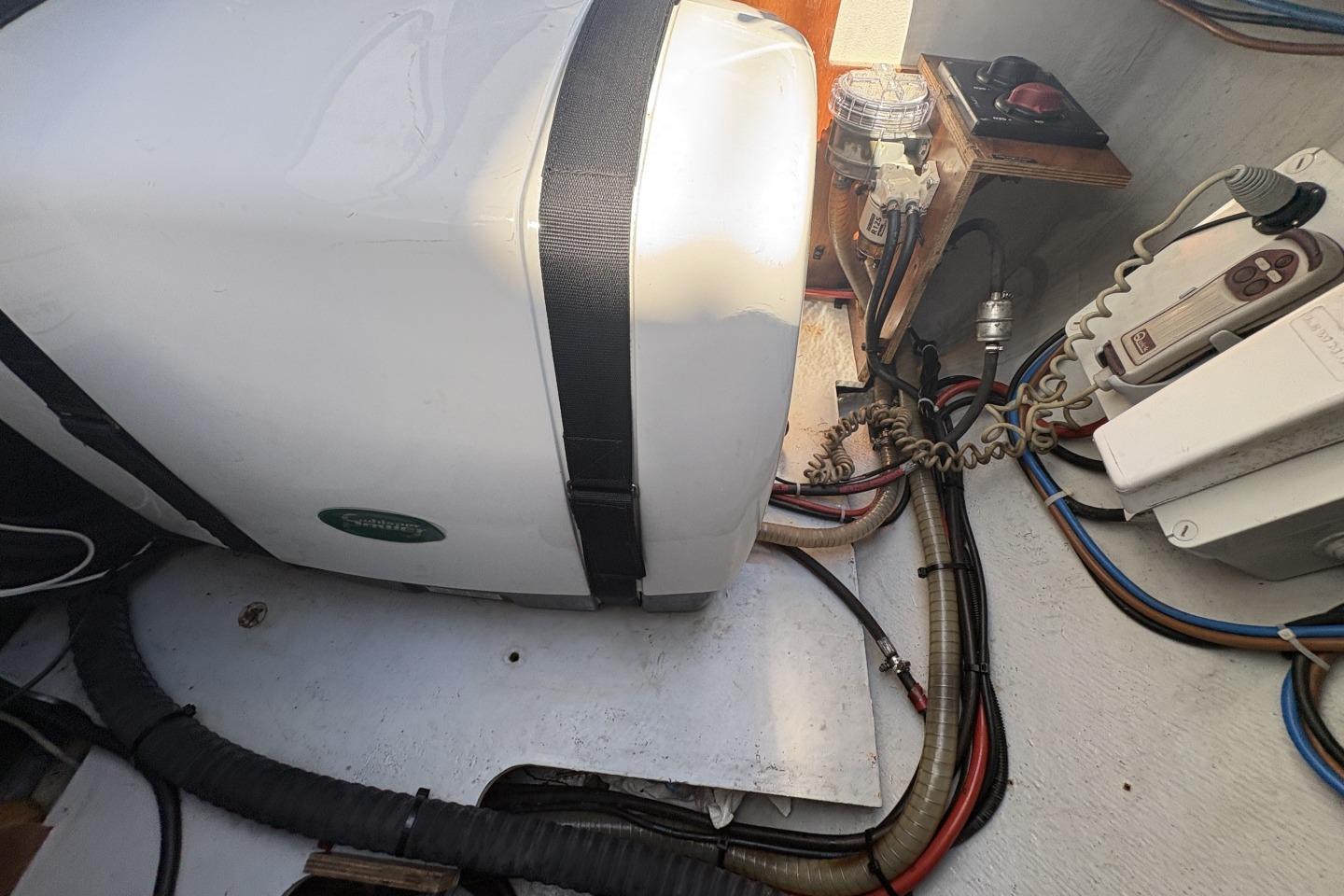 Engine compartment of a 2019 Lagoon 42 catamaran, featuring wiring and equipment.