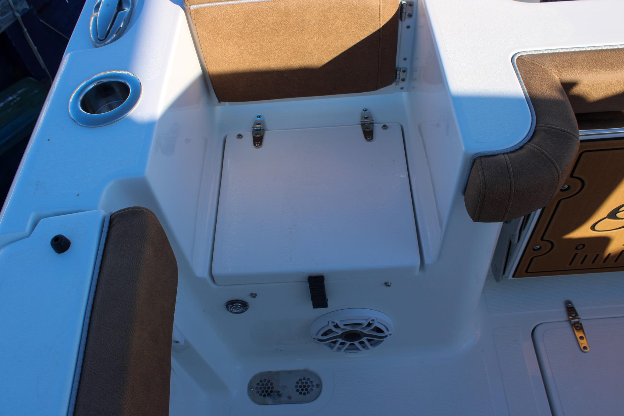 Interior view of 2026 Sea Hunt Gamefish 25 boat, featuring seating and storage area.