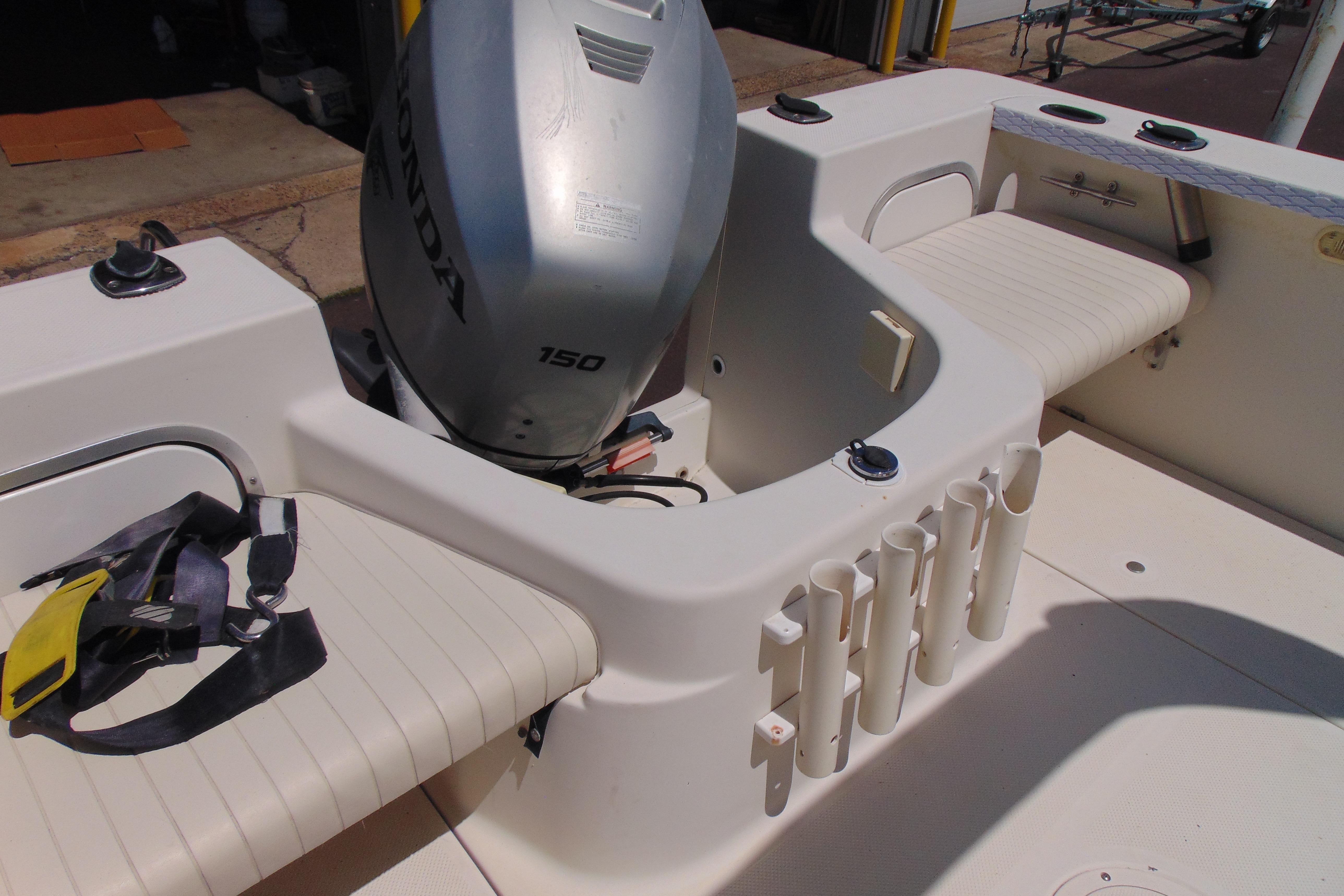 2002 Trophy Walkaround boat interior with Honda 150 engine and seating area.