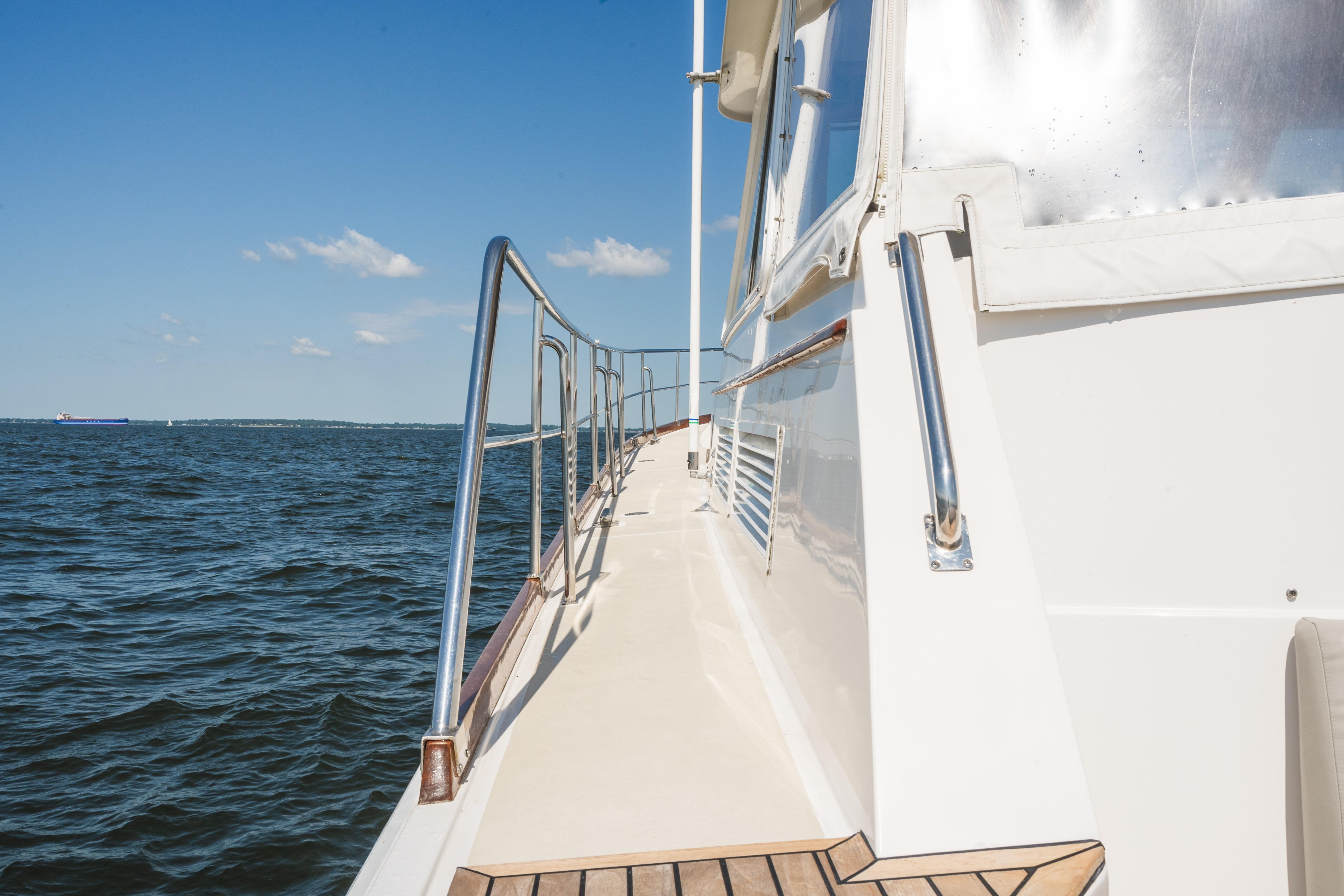 Side view of 1999 Grand Banks 49 Eastbay HX yacht on open water.