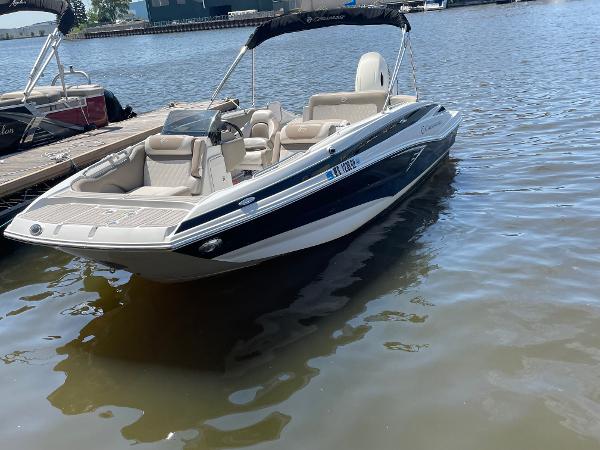 2020 Crownline E 205 XS boat docked on calm water.