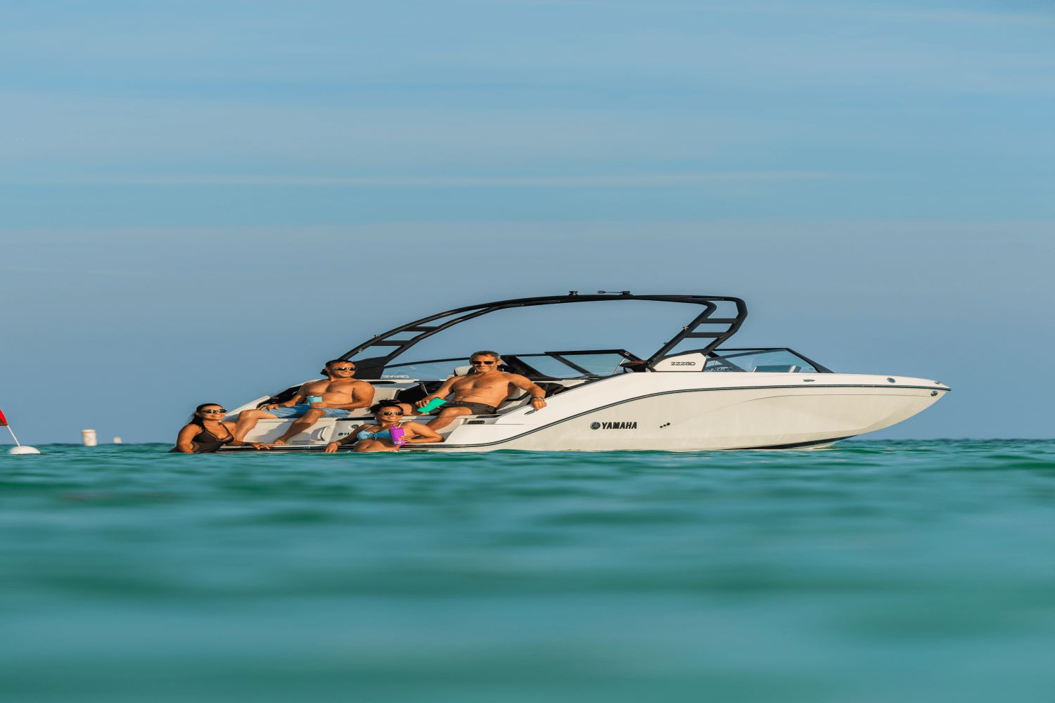 Yamaha 222SD boat from 2026 on the water with four people on board.
