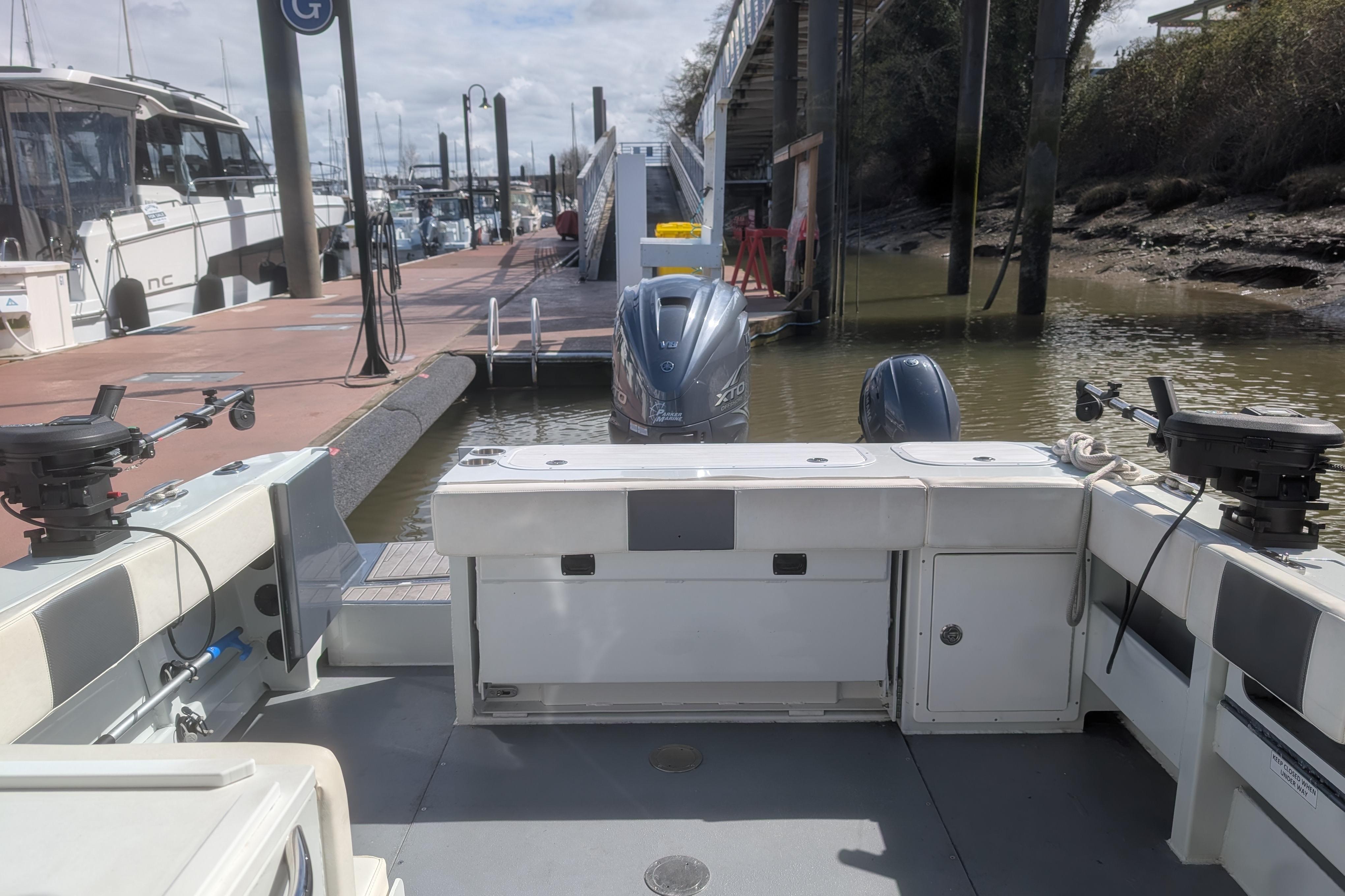 2021 LIGHTHOUSE 264 SF boat docked at marina with twin engines visible.