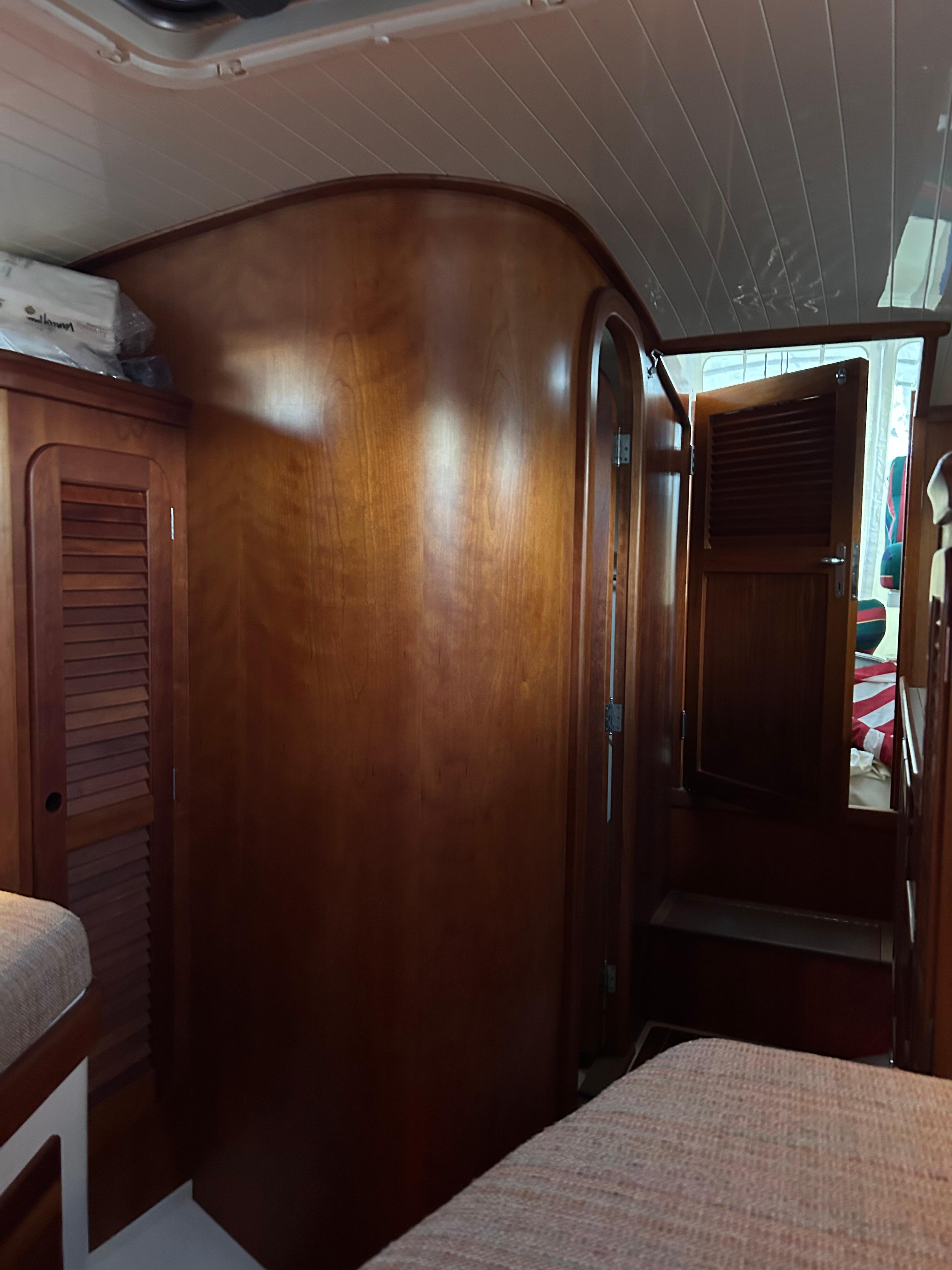 Interior of 2001 Hinckley Classic 36 Picnic Boat with wooden cabinetry and cozy seating.
