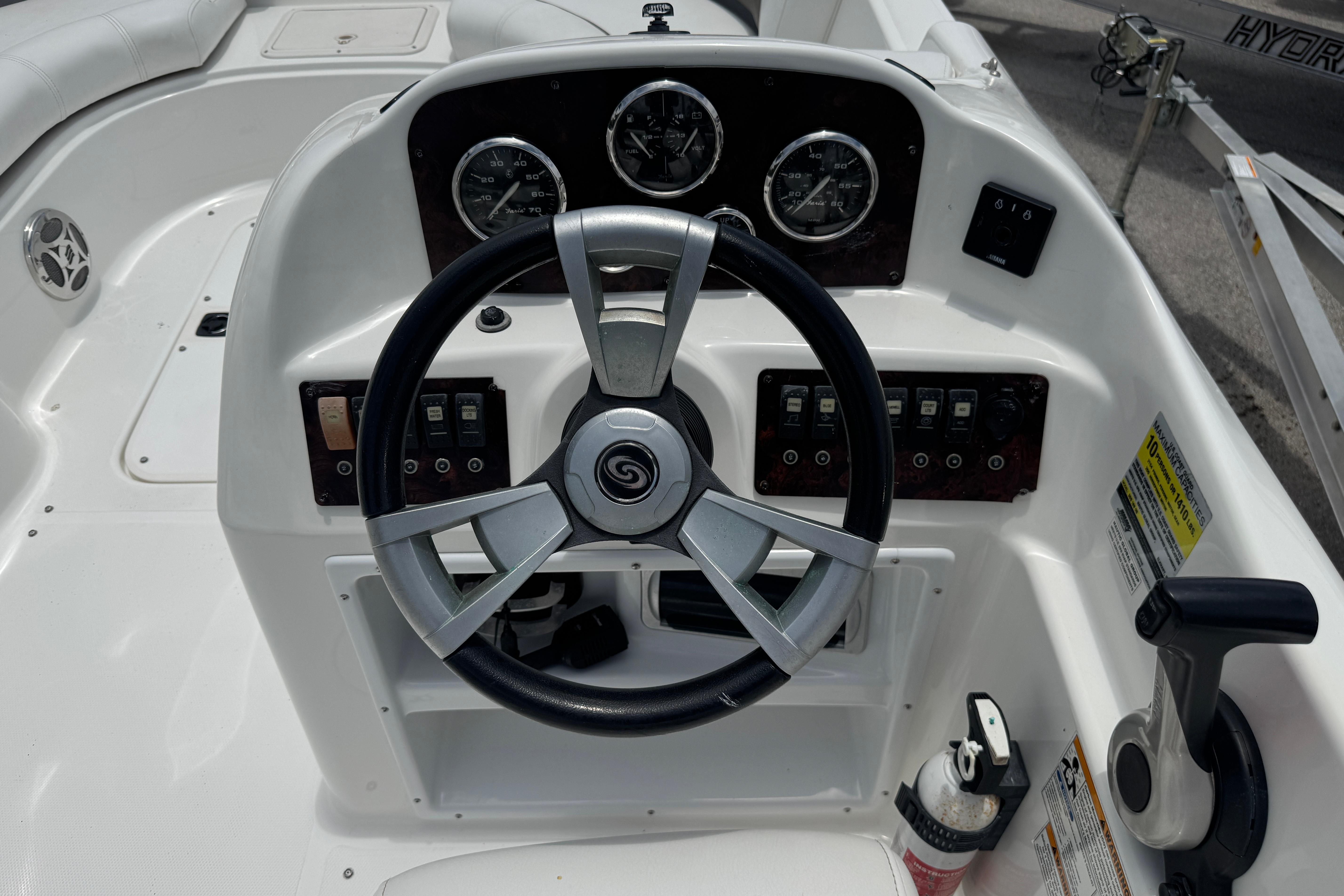 Steering console of 2013 Hurricane SunDeck Sport 188 OB boat with gauges and controls.