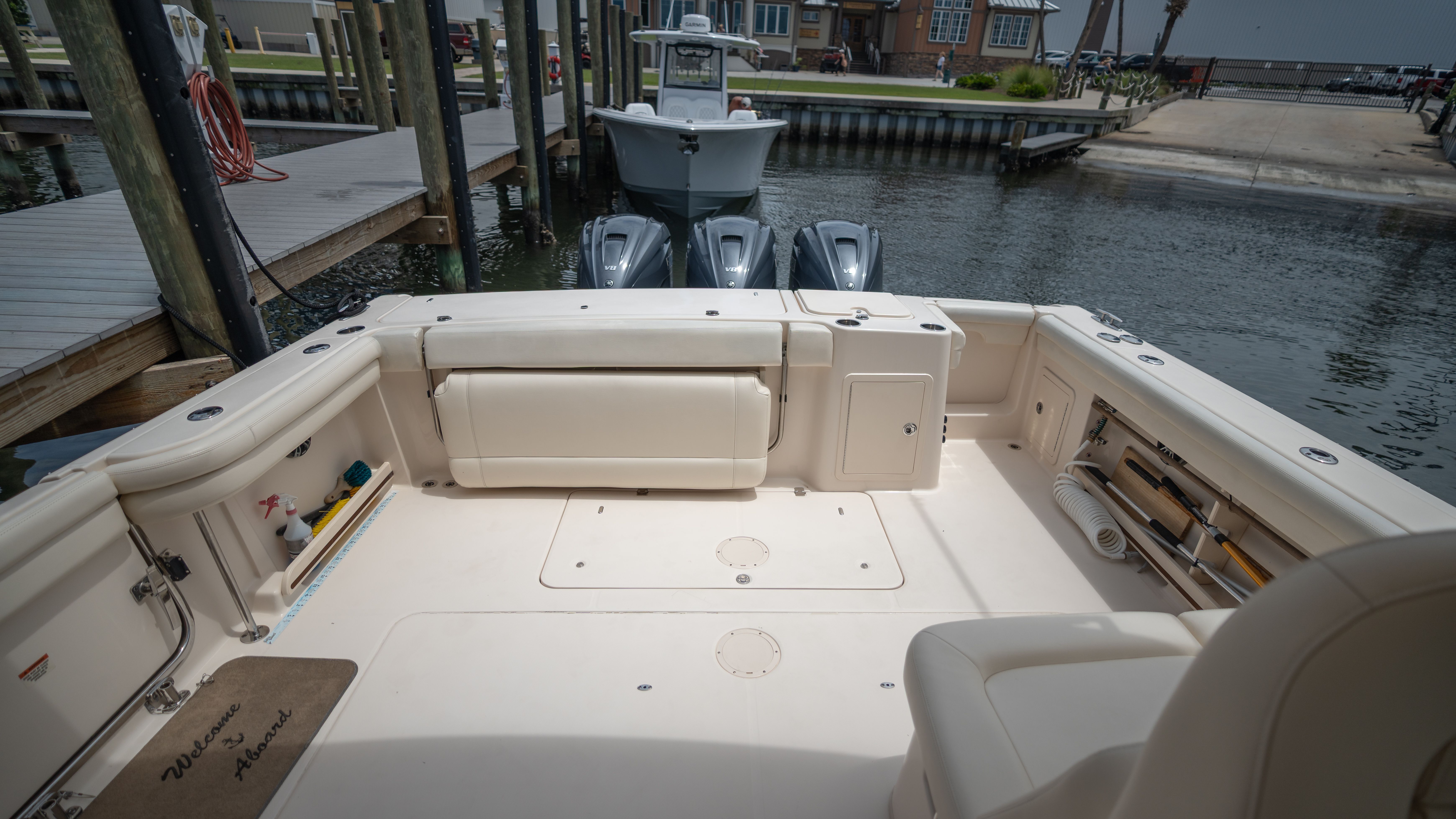 The image shows the spacious aft deck of a Grady-White 375 Freedom boat in a marina.