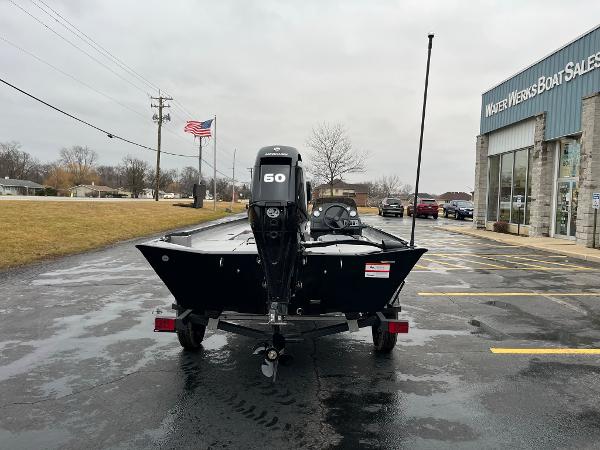 2024 Lowe Legacy boat at dealership, rear view with 60 HP motor.
