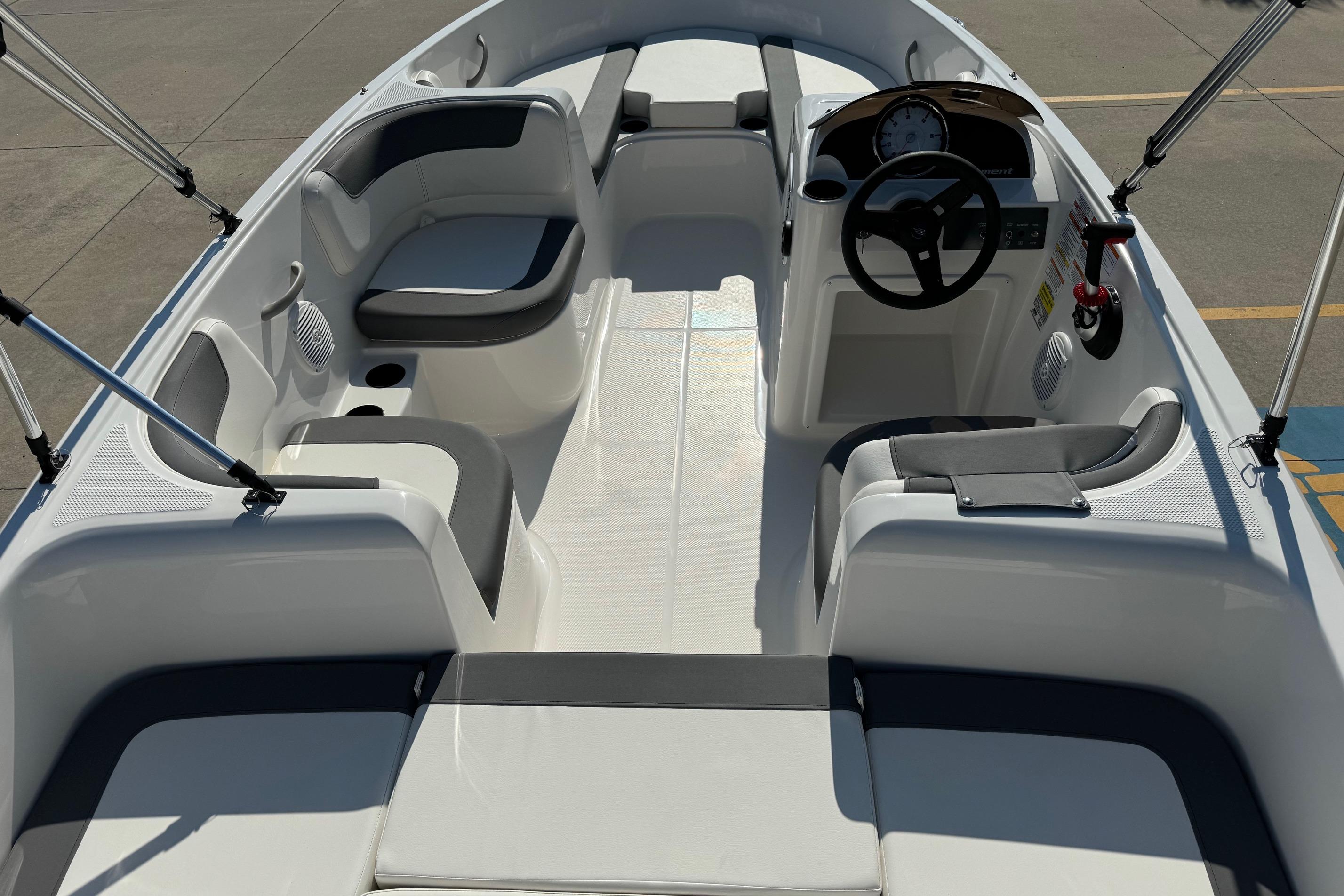 2025 Bayliner Element E16 boat interior with seating and steering console.