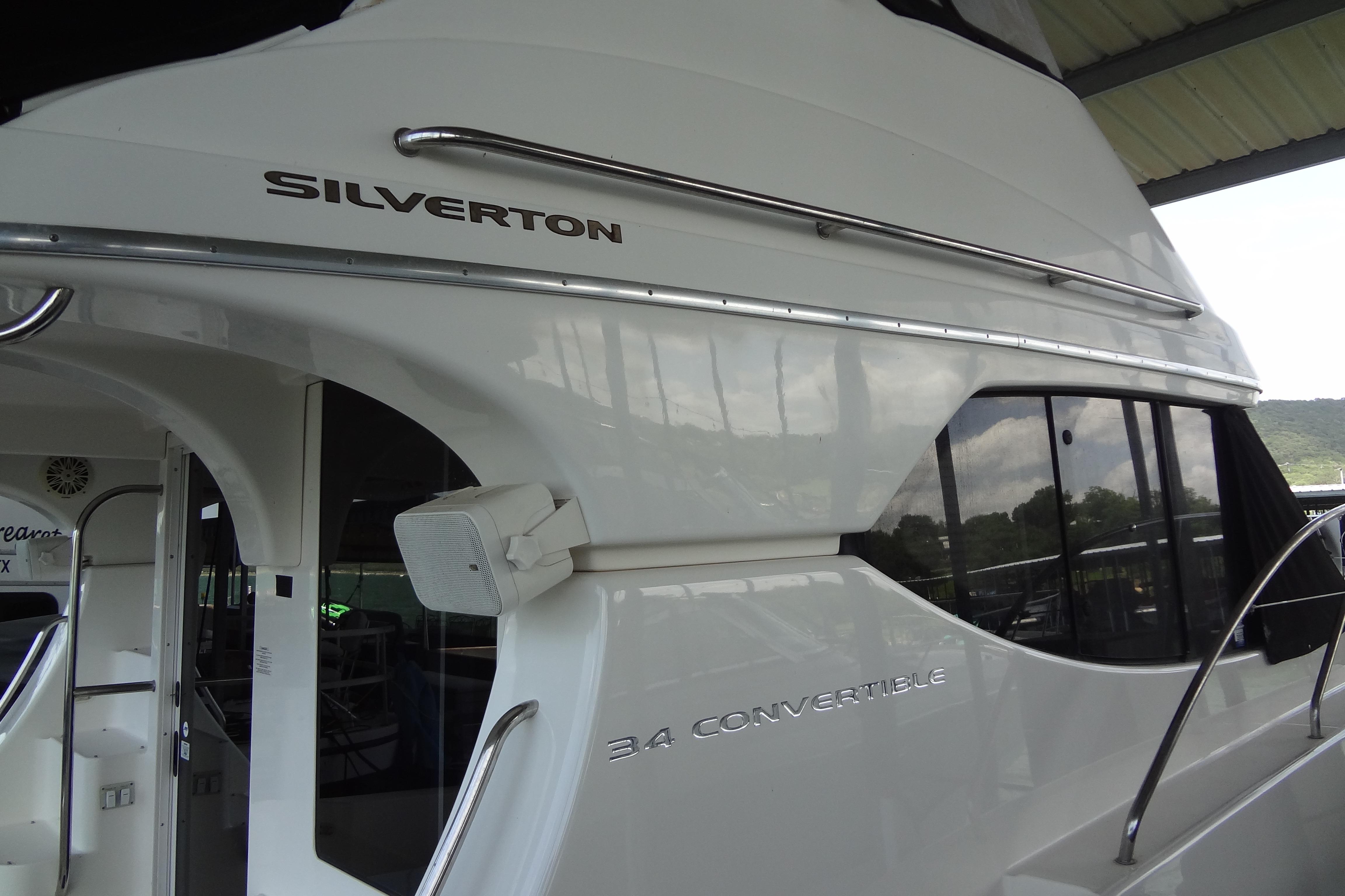 2005 Silverton 34 Convertible yacht, sleek white exterior with large windows.