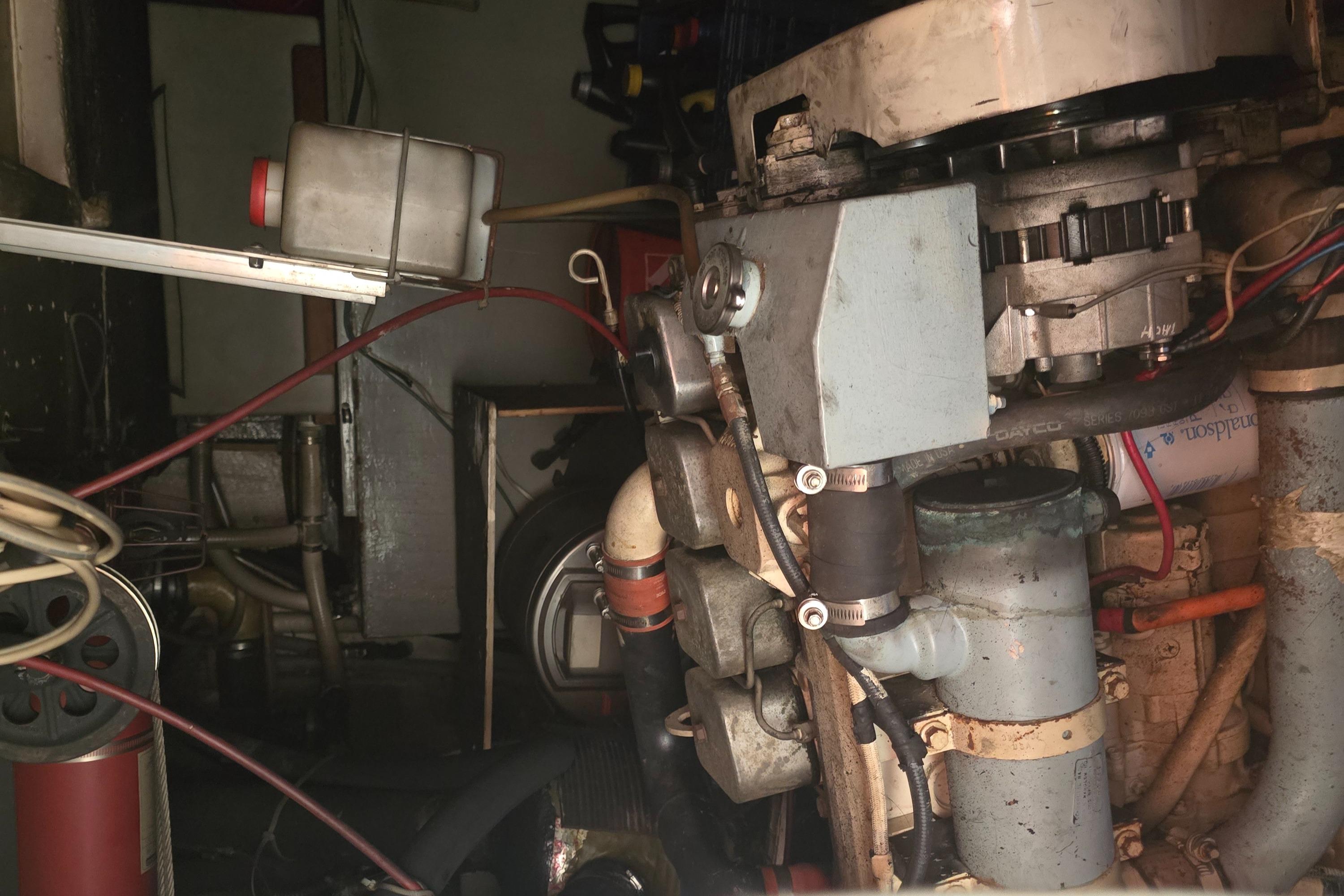 Engine room of a 1978 Herreshoff 50, showcasing mechanical components and wiring.