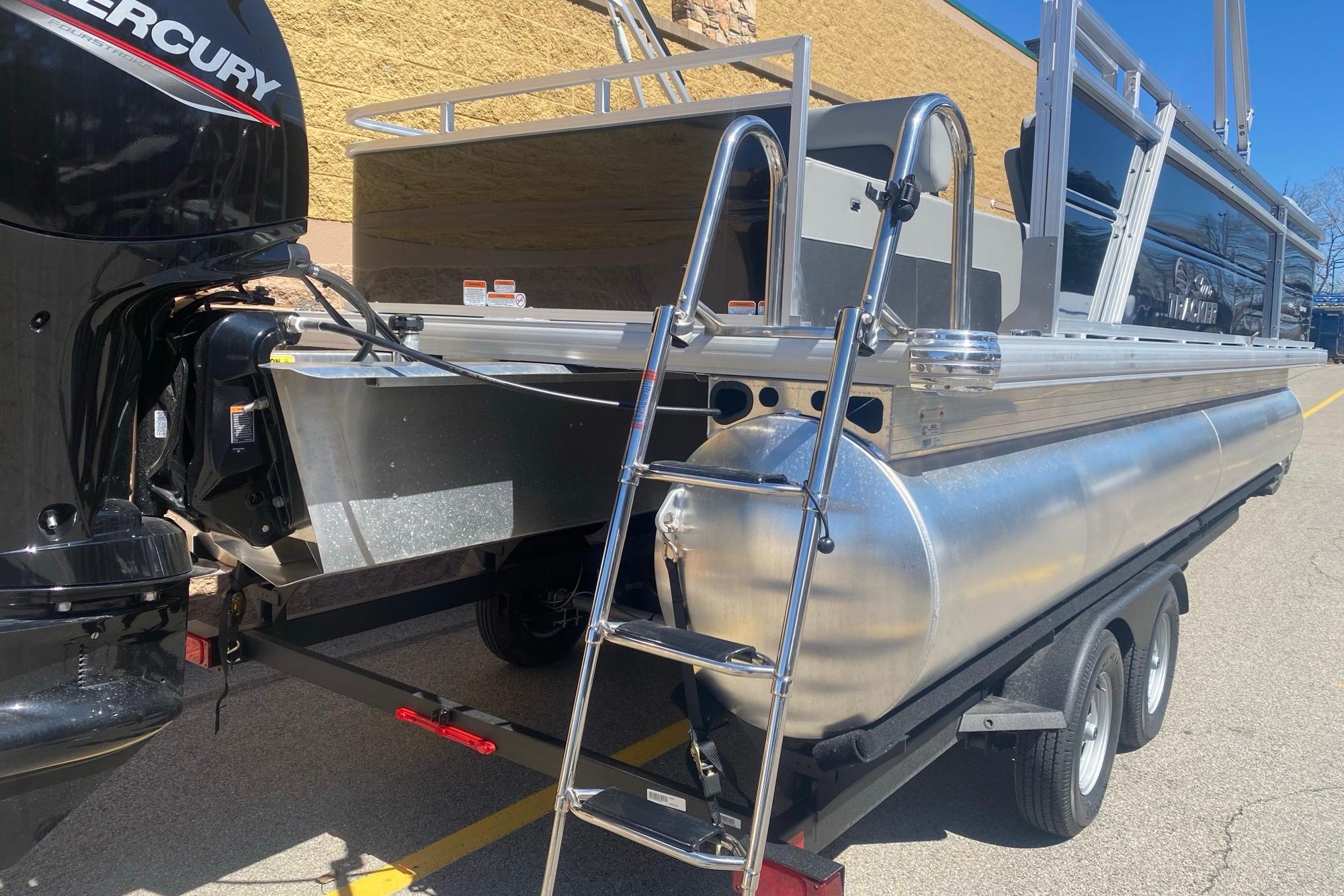 2026 Sun Tracker Party Barge 22 RF DLX on trailer with Mercury outboard motor.