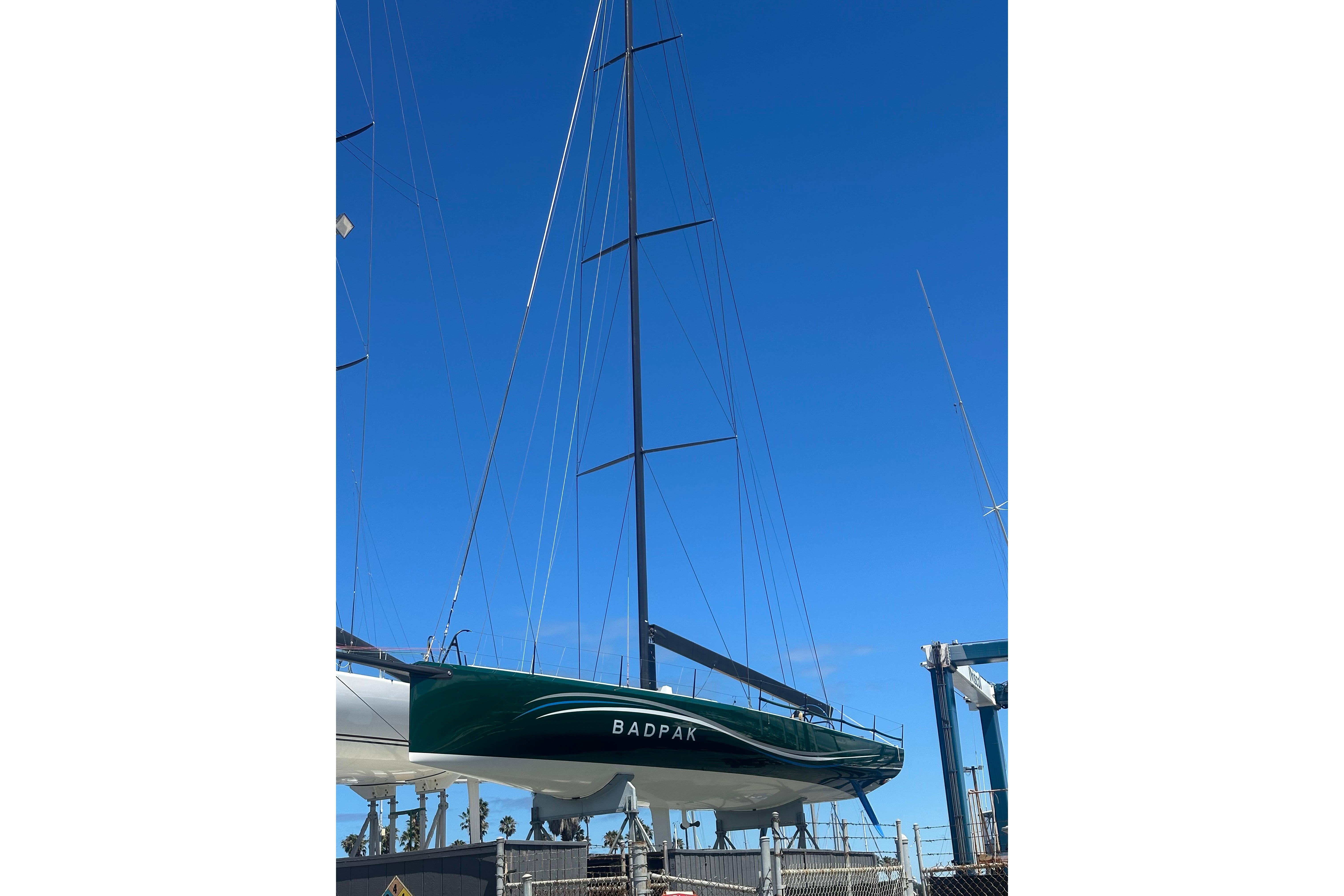 Sleek 2018 Botin 56 sailboat with tall mast against clear blue sky.