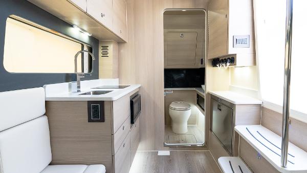 Luxurious interior of 2025 Scout 425 LXF boat featuring modern kitchen and bathroom amenities.