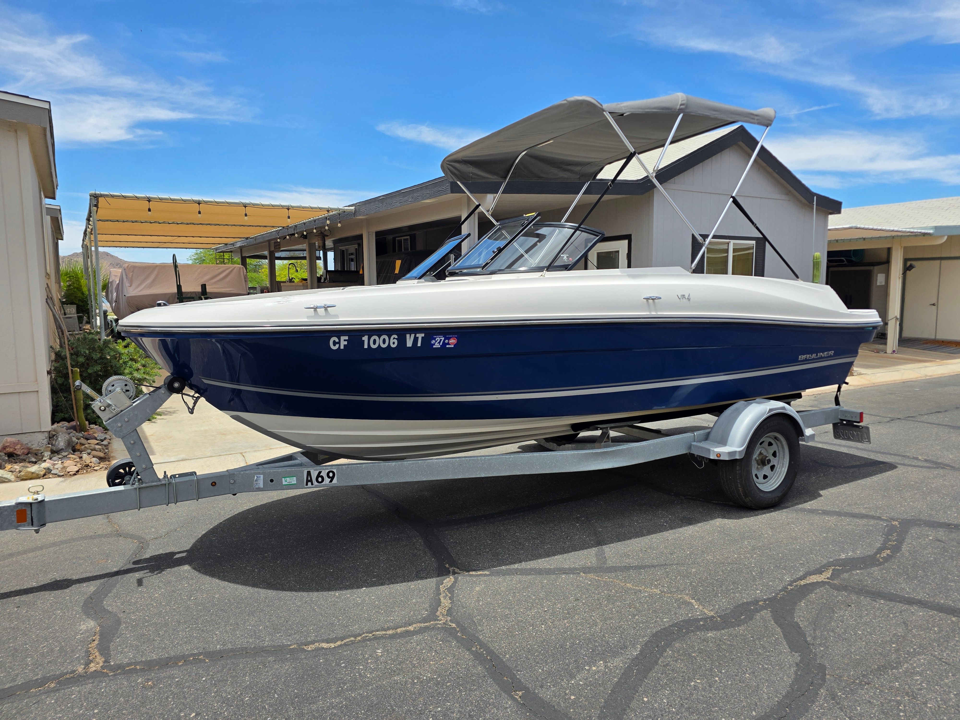 A 2021 Bayliner VR4 Bowrider I/O on a trailer, parked on a street.