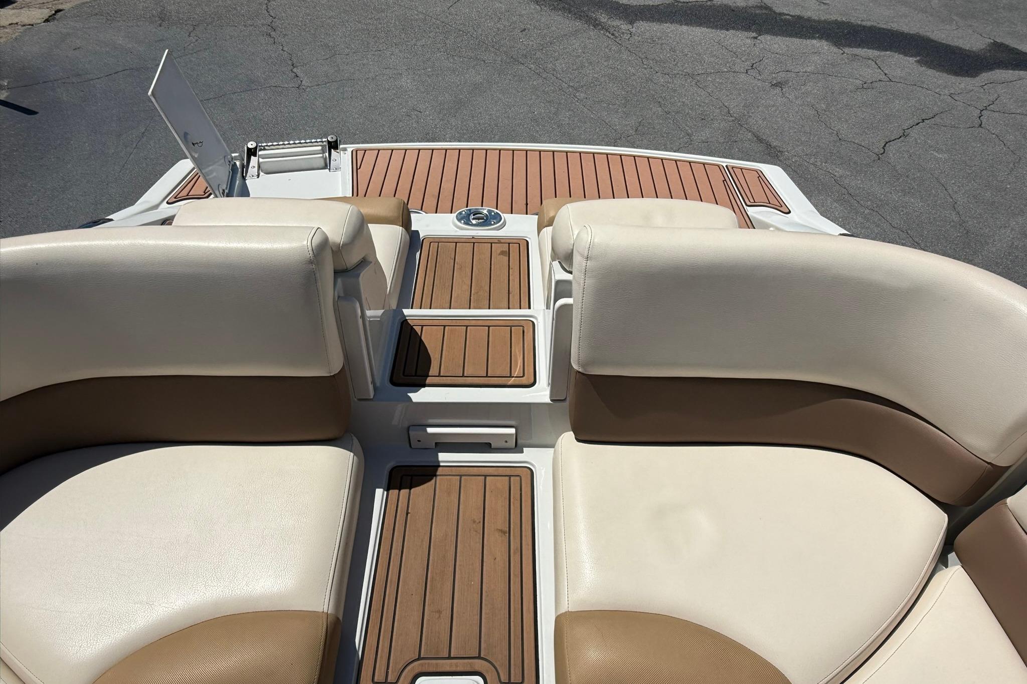 2016 Crownline 255 SS boat interior with beige seating and wood accents.