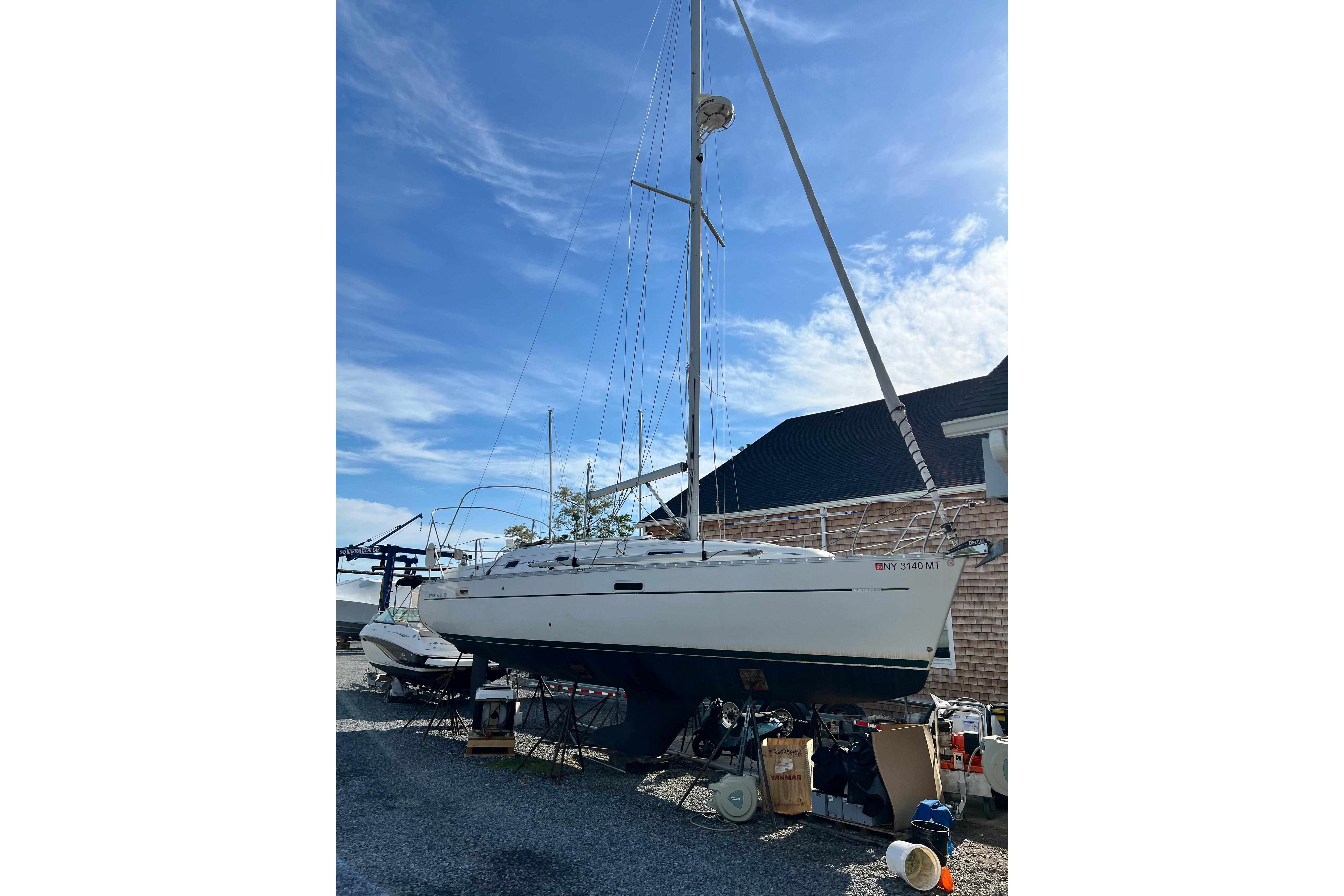 2001 Beneteau 331 sailboat on dry dock, clear sky background.