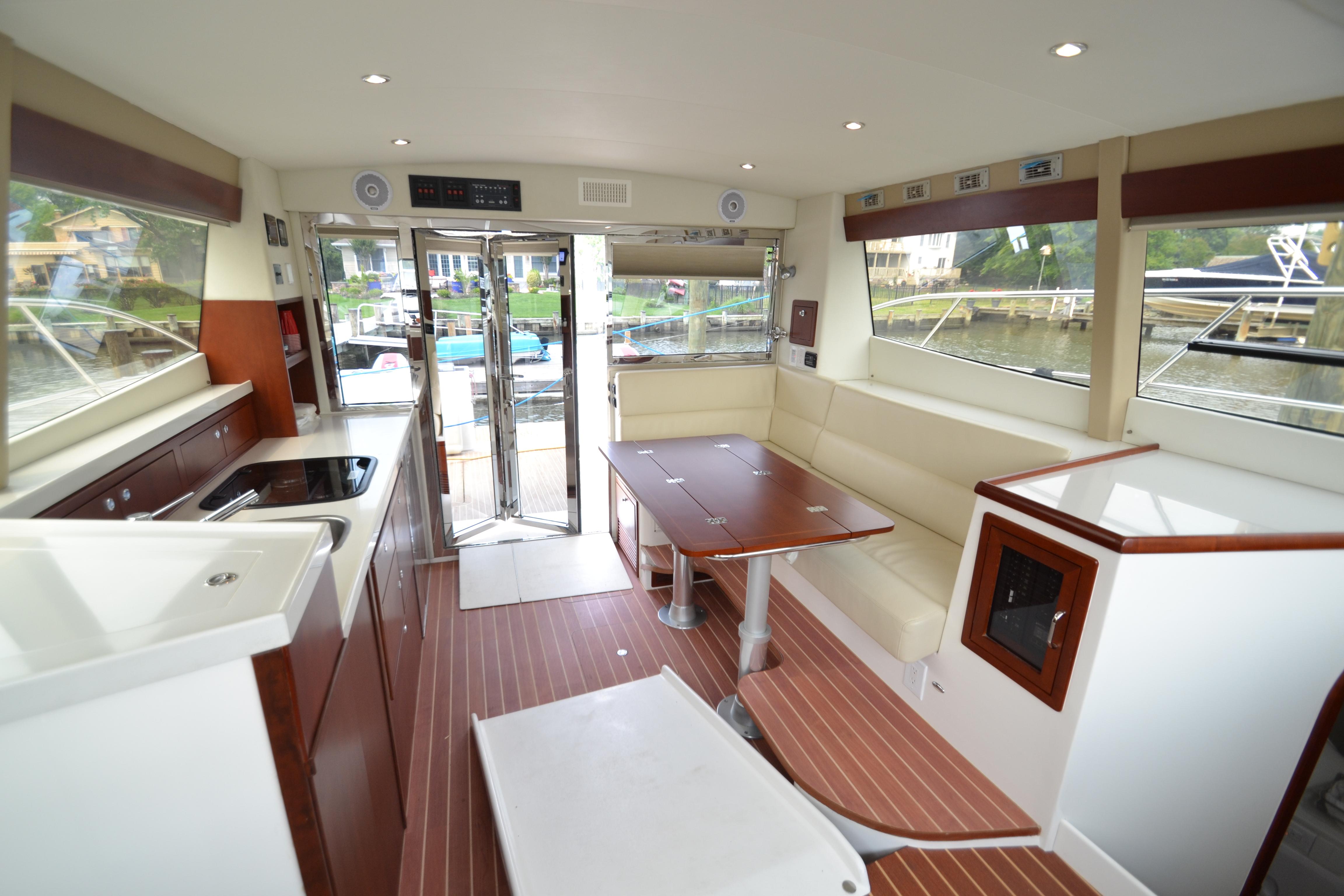 Interior of 2022 ArrowCat 42 Coupe, featuring modern kitchen and seating area.