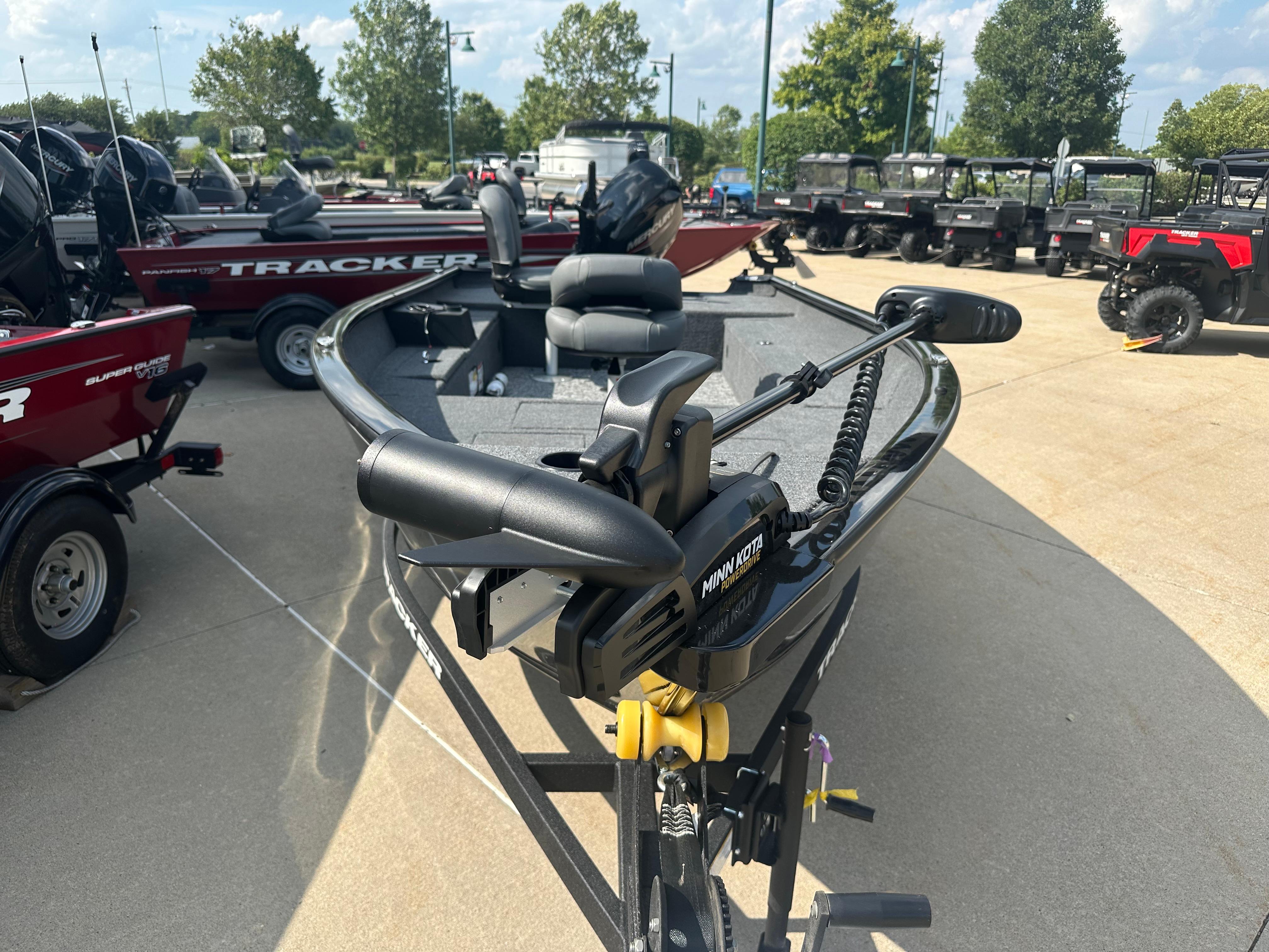 2025 Tracker Super Guide V-16 T boat with Minn Kota motor in outdoor showroom.
