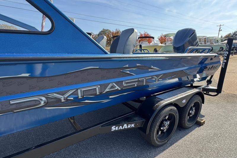 2026 SeaArk Dynasty 2.0 boat in blue, on a trailer, side view.