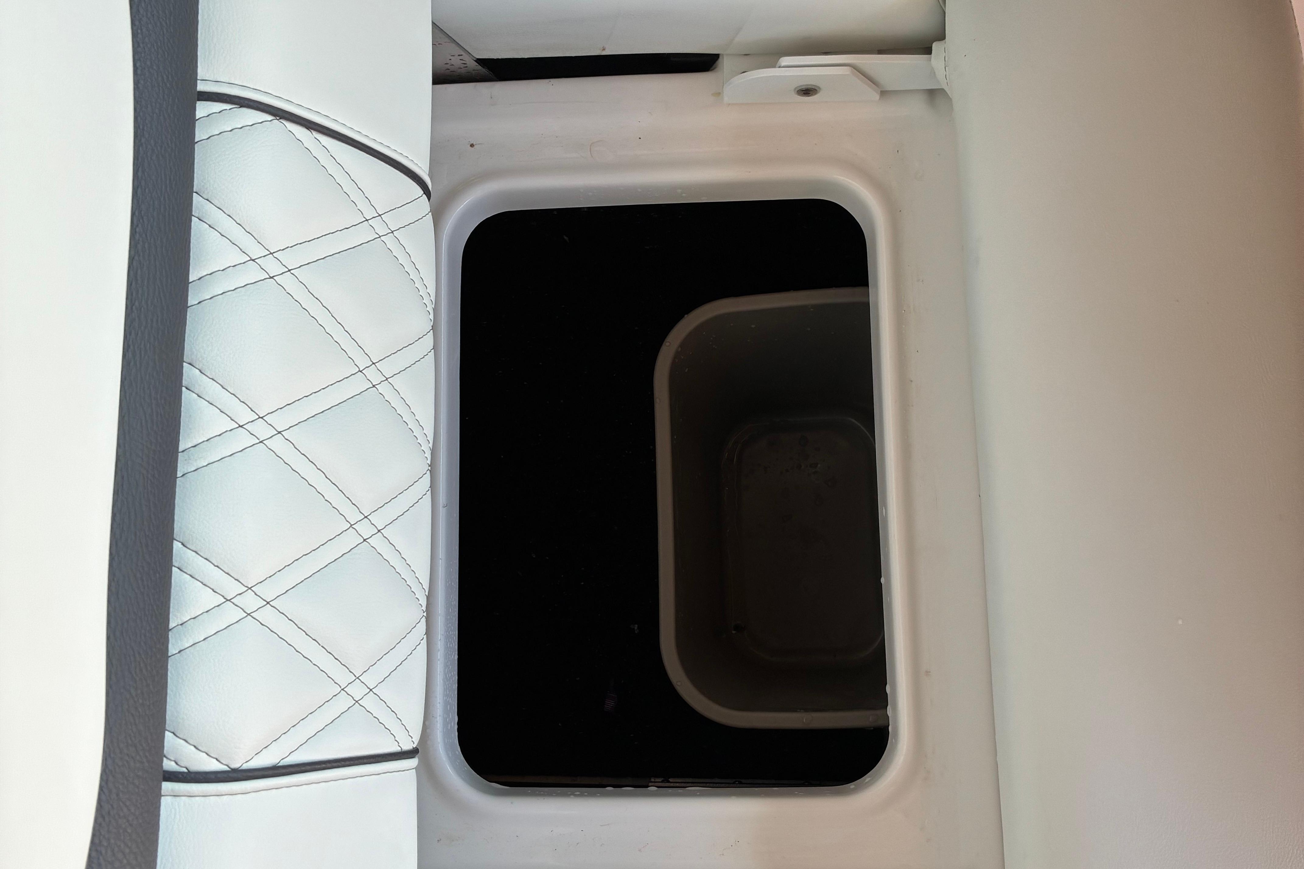 2025 Regal LS2 boat storage compartment with quilted white leather seating.