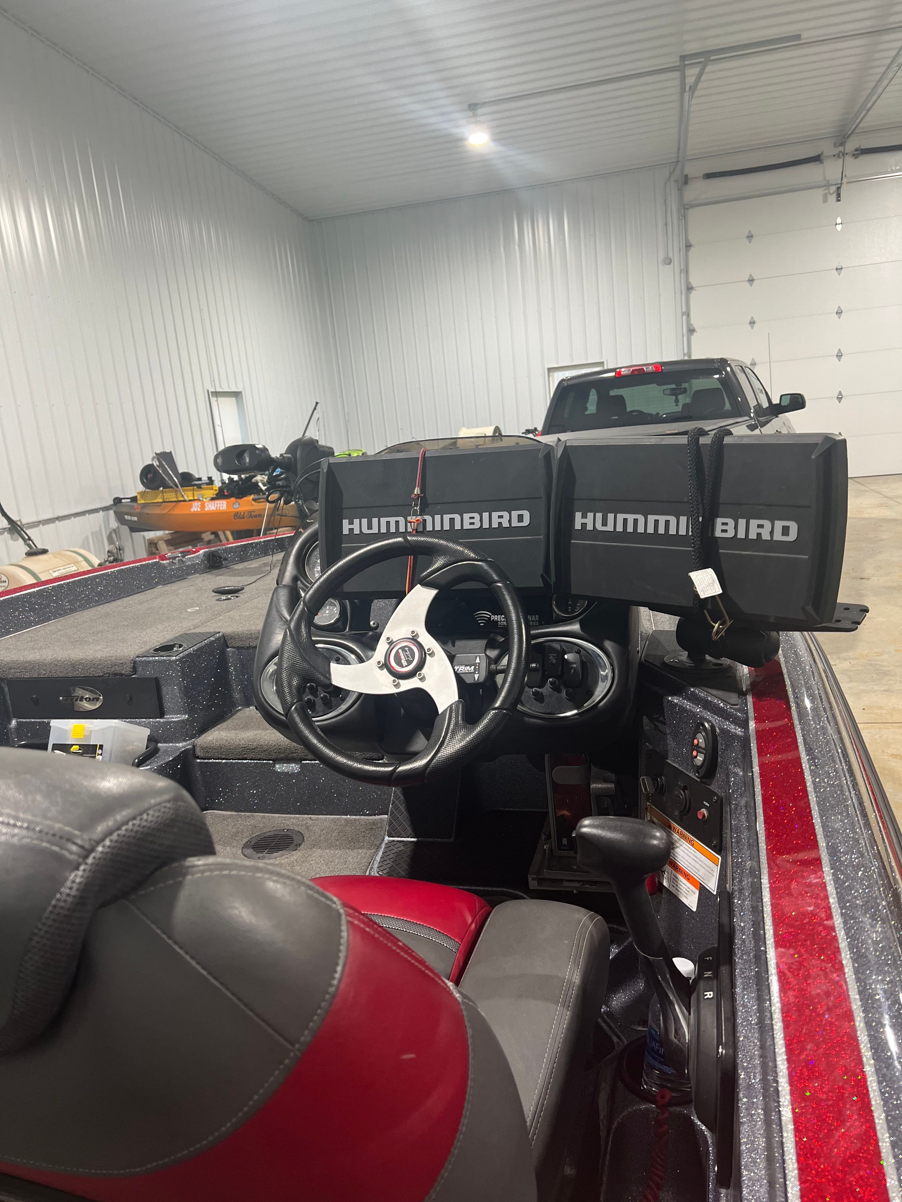 Interior view of a 2015 Triton 18XS with two Humminbird screens at the helm.