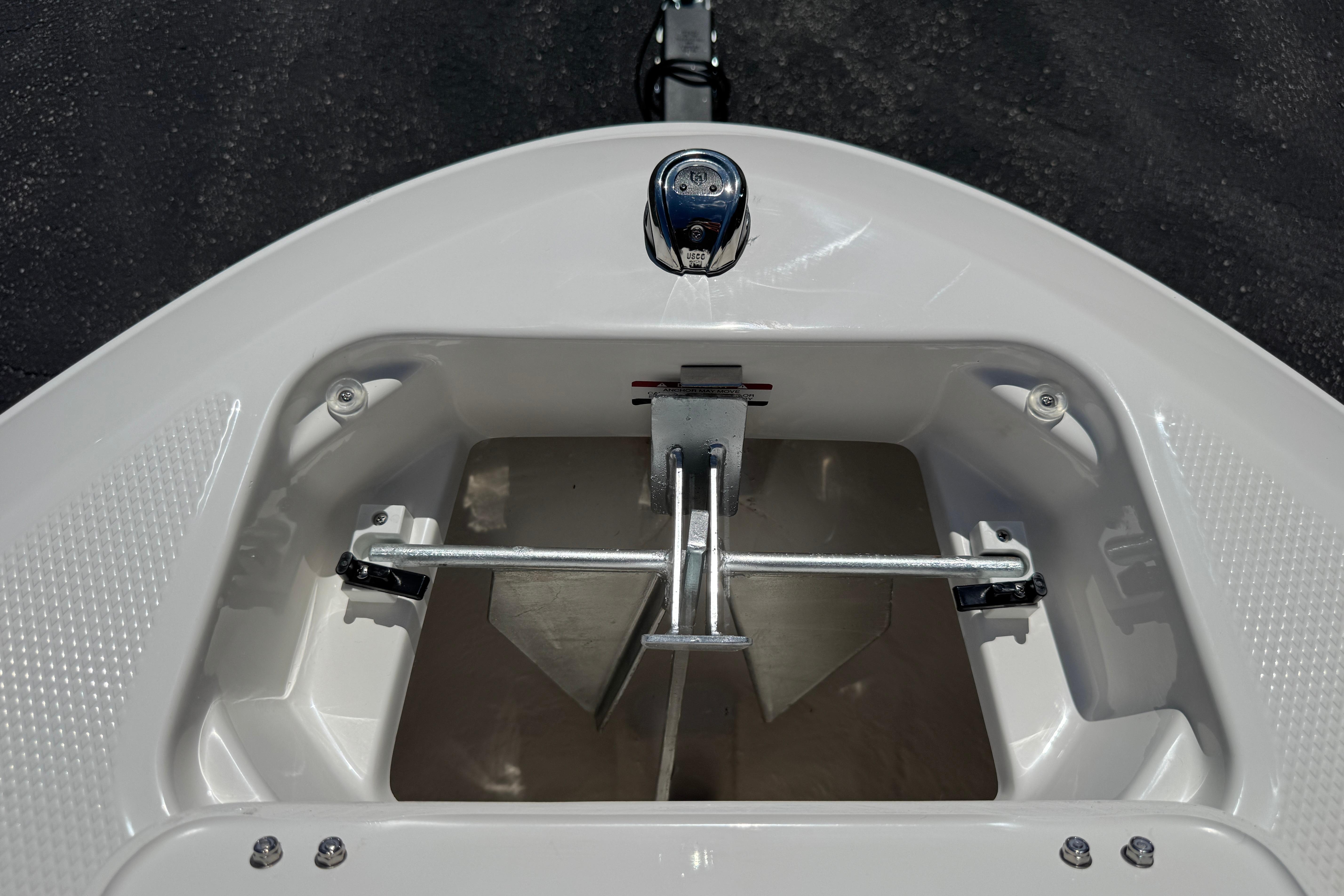 Bow storage compartment of 2026 Chaparral 21 SSi boat, featuring anchor holder.