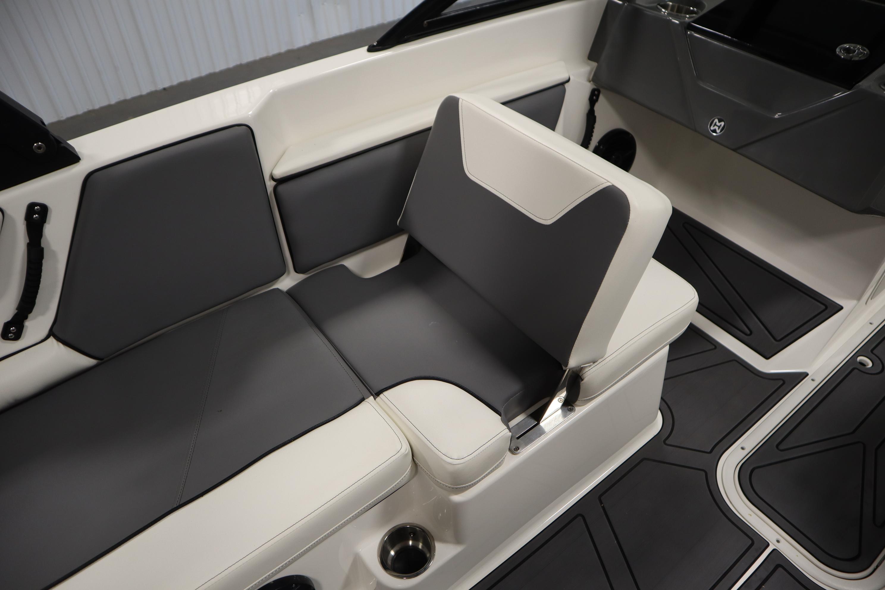 2023 Heyday WT Surf boat interior with gray and white seating and cup holders.