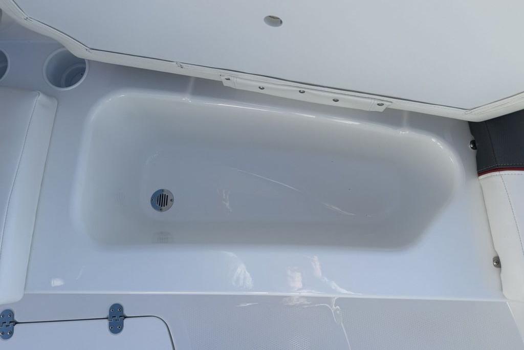 2026 Tahoe T16 boat interior storage compartment with drain plug.