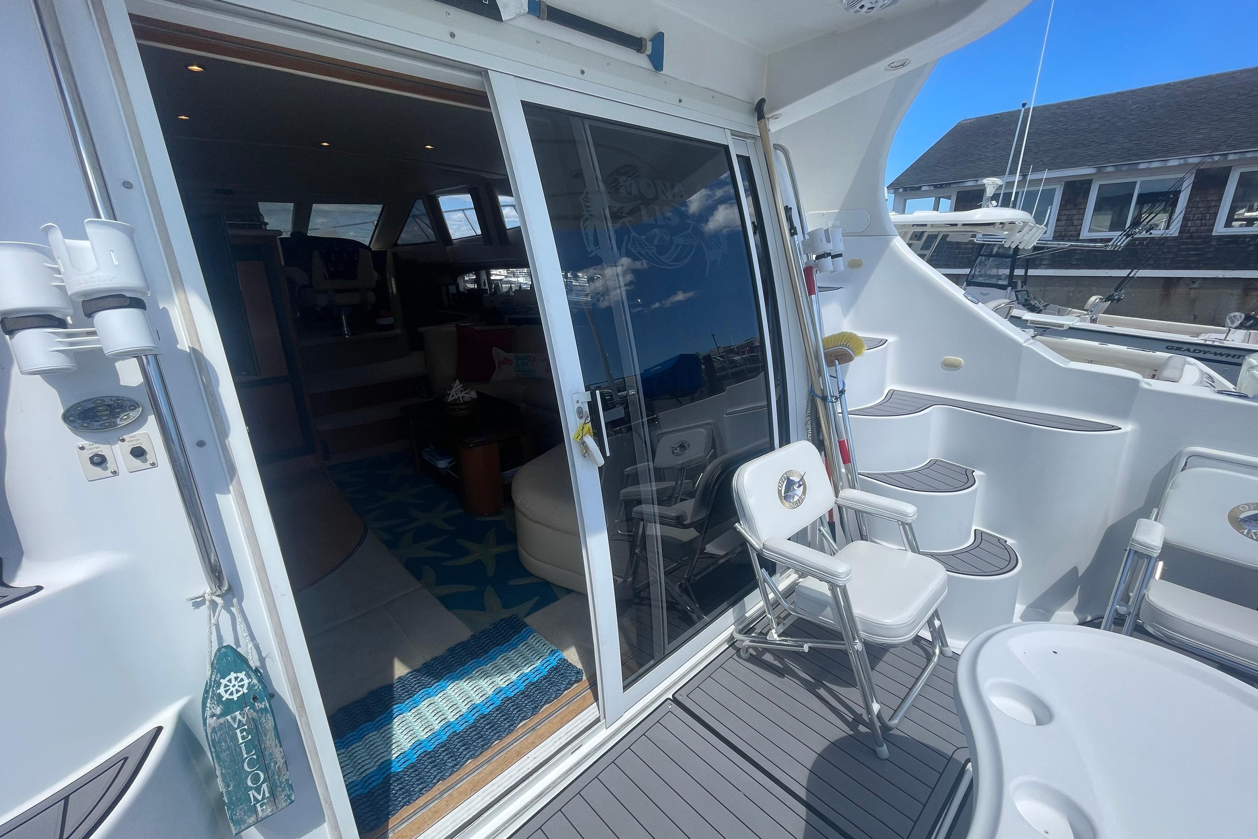 2002 Carver 410 Sport Sedan yacht interior with open sliding door and deck seating.