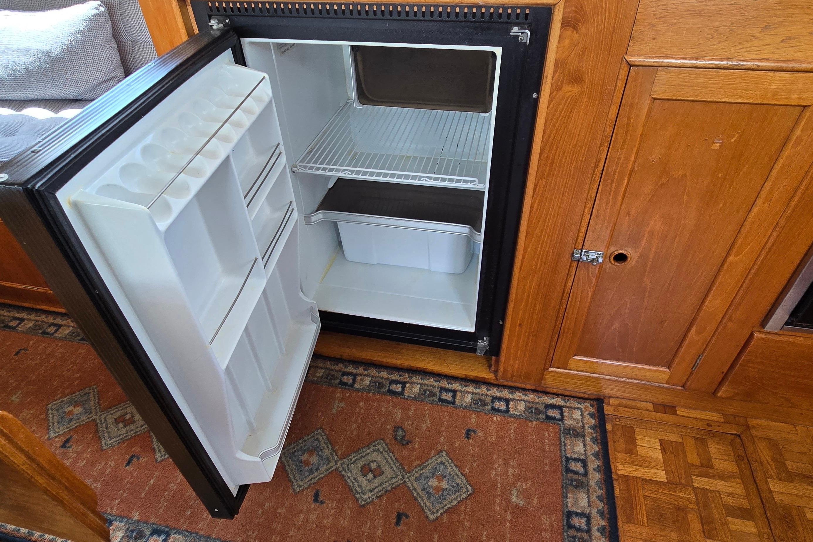 Open refrigerator inside a 1980 Grand Banks 36 Classic yacht interior.