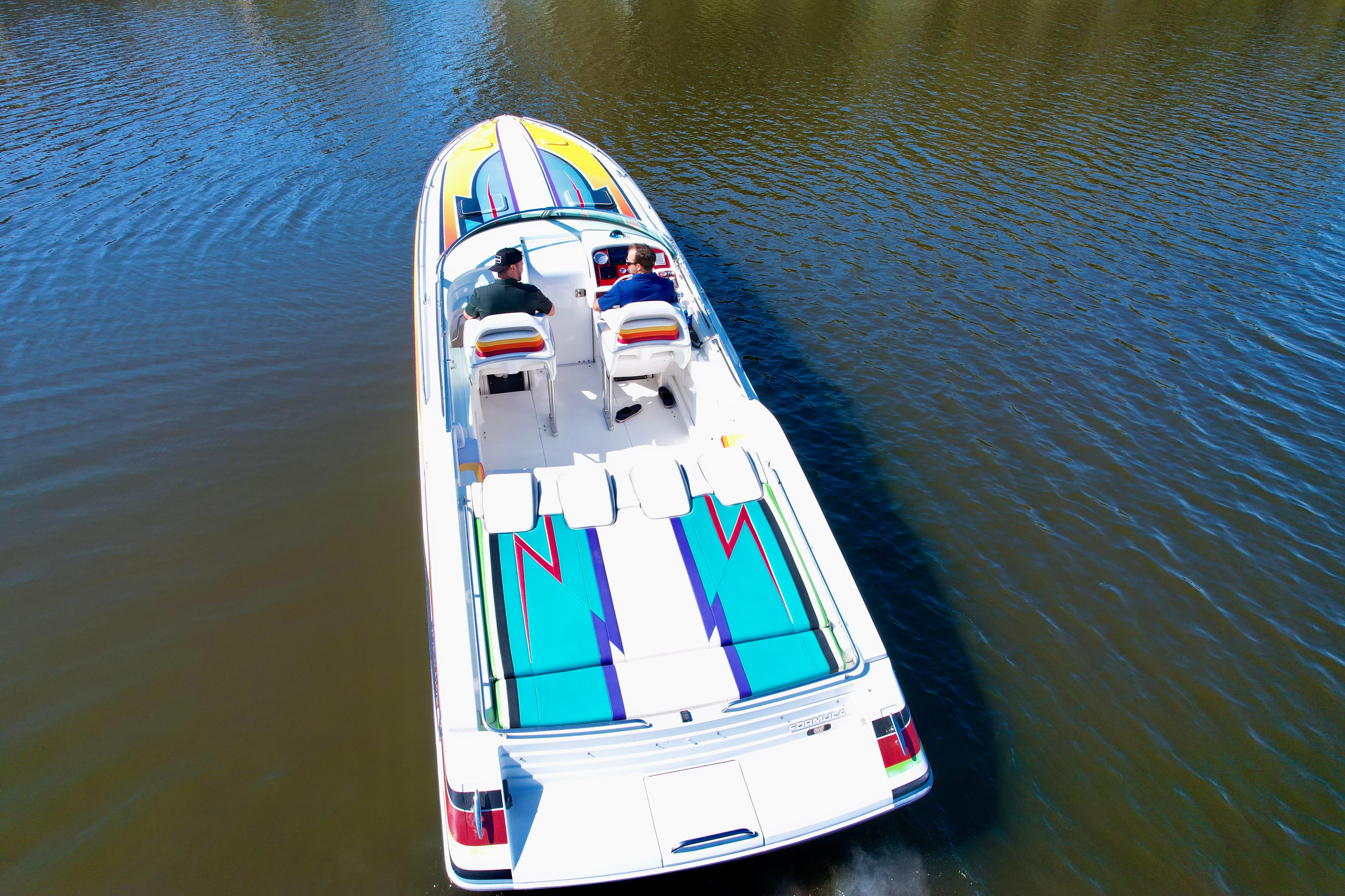 2006 Formula 382 FASTech speedboat cruising on calm water, aerial view.