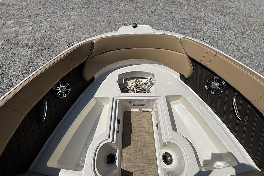 2019 Sea Ray SPX 230 Outboard boat interior with tan seating and storage compartments.