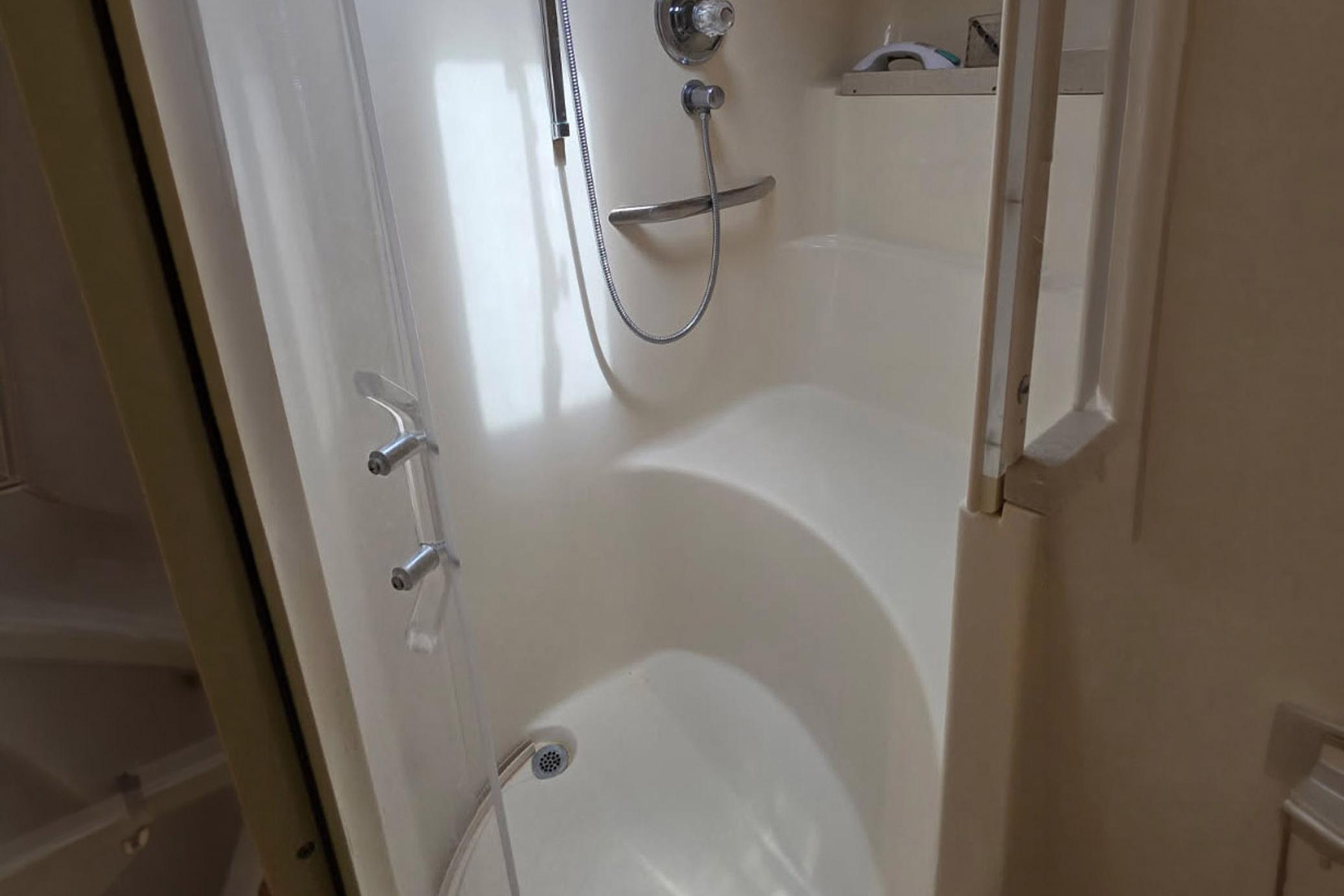 Shower area inside 1998 Sea Ray Sundancer 400 yacht, featuring sleek design and fixtures.
