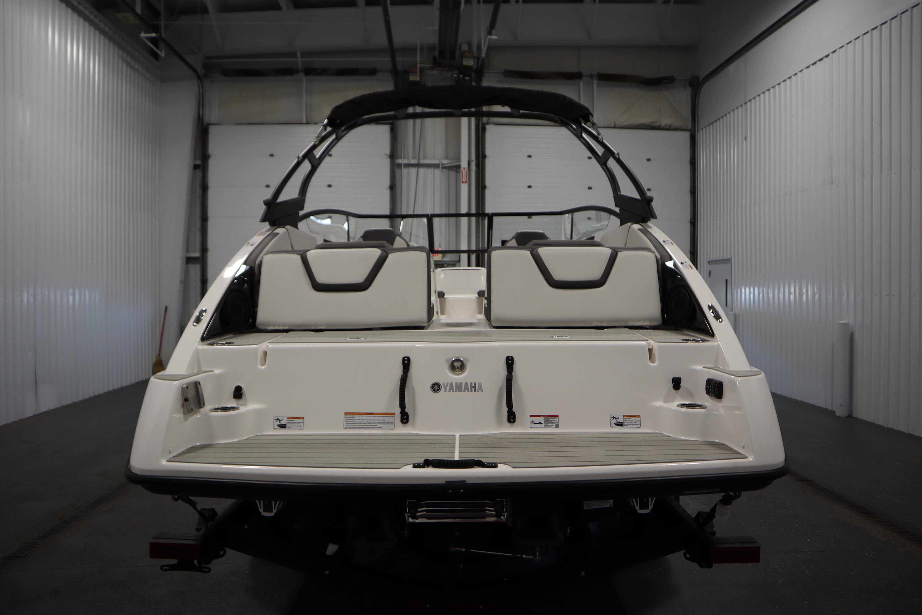 2026 Yamaha Boats AR250 in a garage, rear view showcasing seating and design.