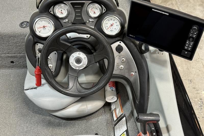 2016 Tracker Pro Team 175 TXW boat dashboard with steering wheel and Humminbird fish finder.