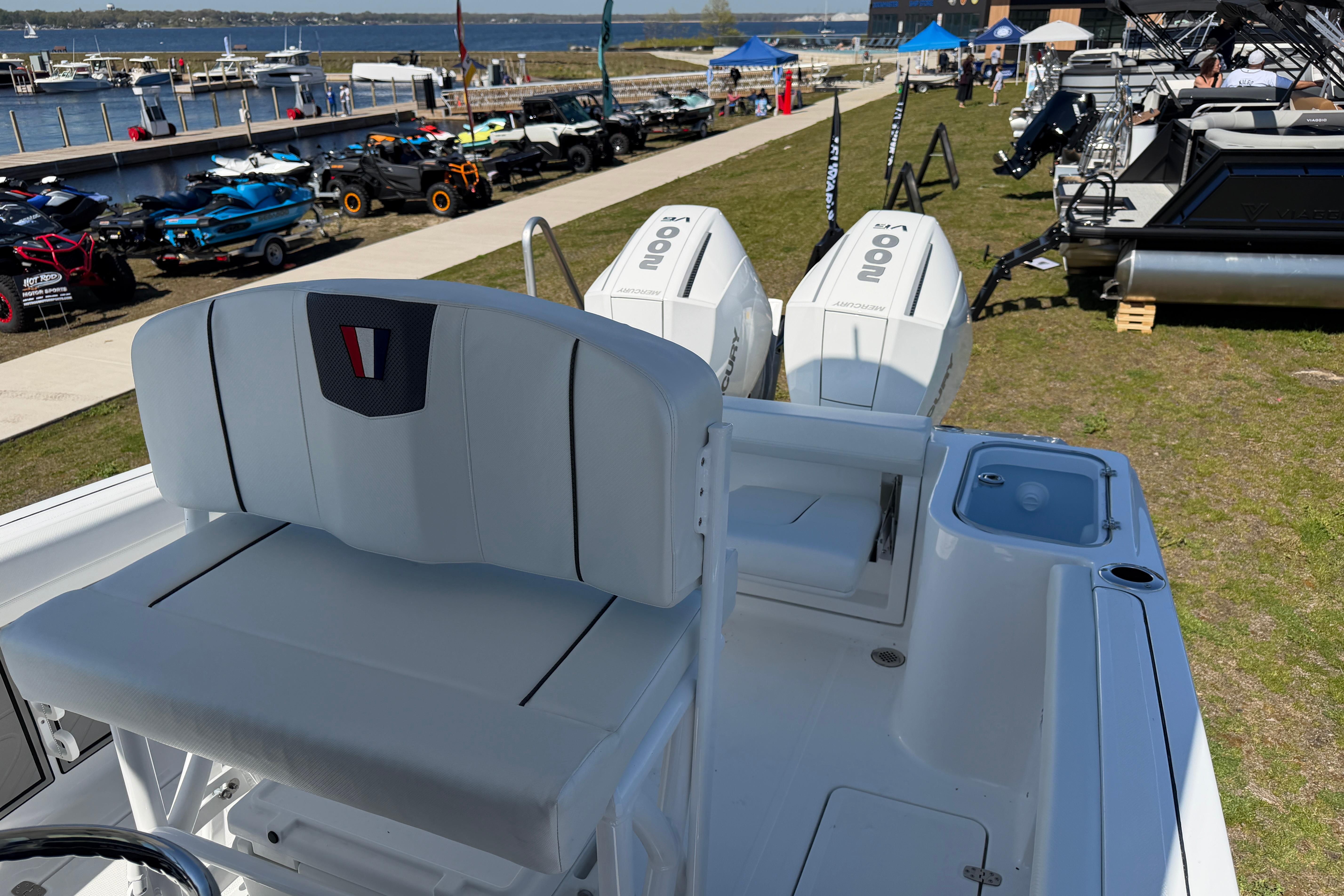 2026 Wellcraft 243 Fisherman boat with dual outboard engines at the marina.